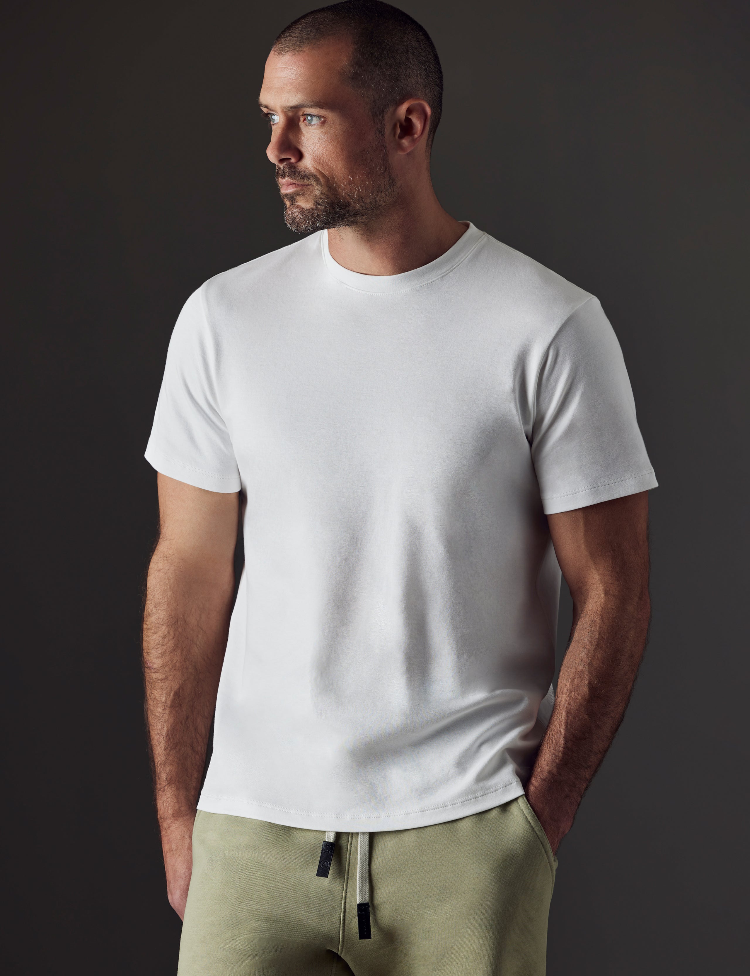 Man wearing white organic cotton tee from AETHER Apparel