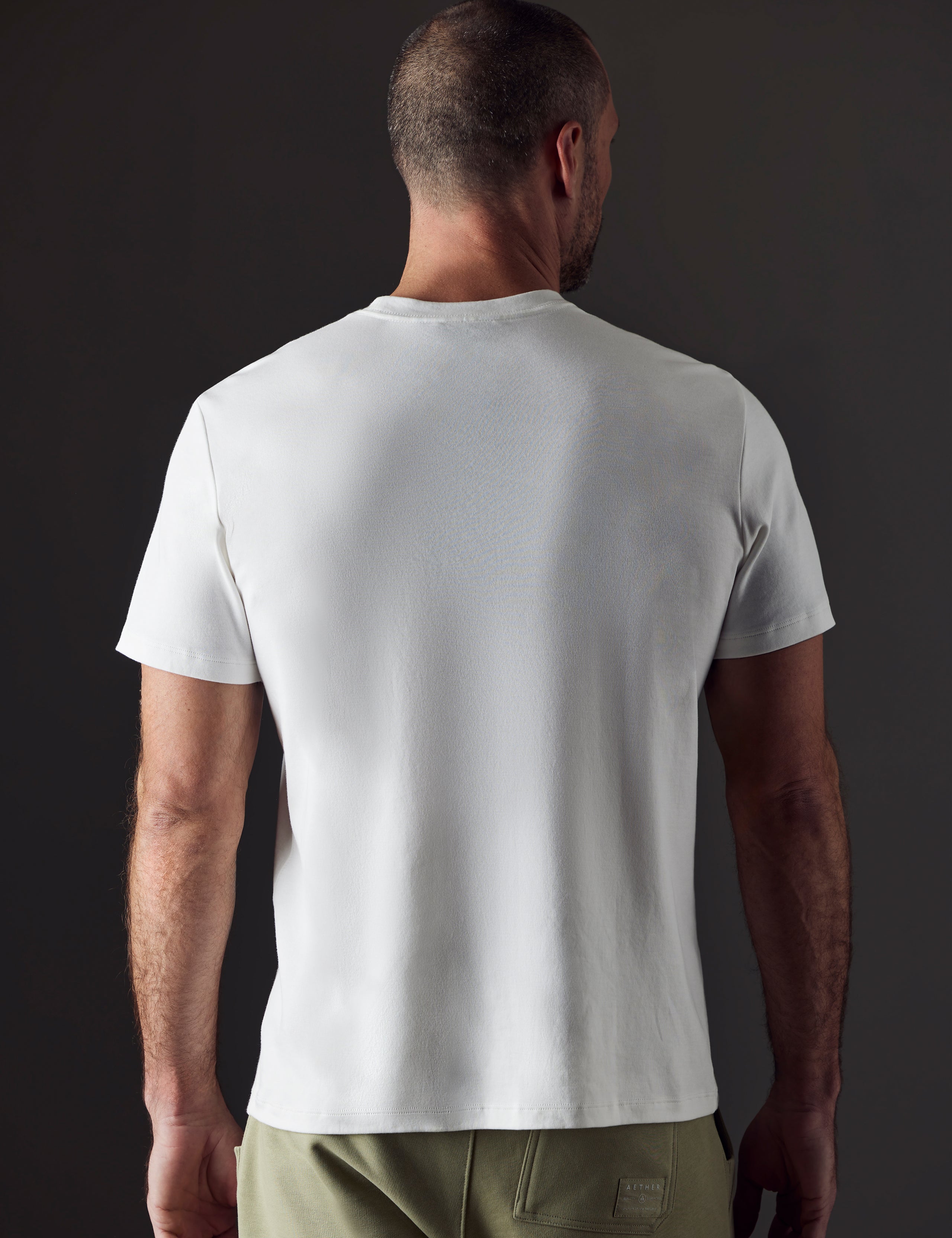 Man wearing white organic cotton tee from AETHER Apparel