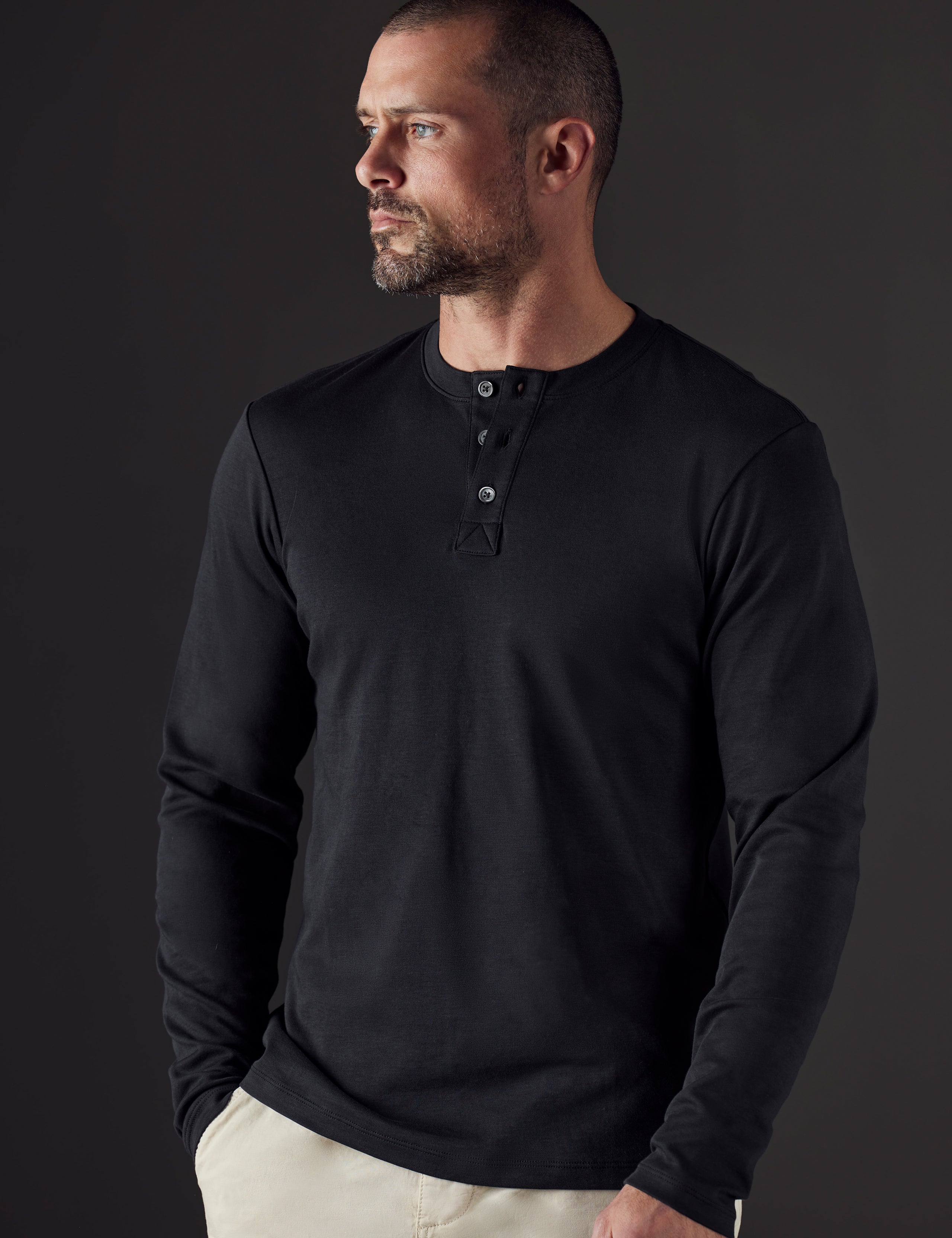 Man wearing black organic cotton henley from AETHER Apparel