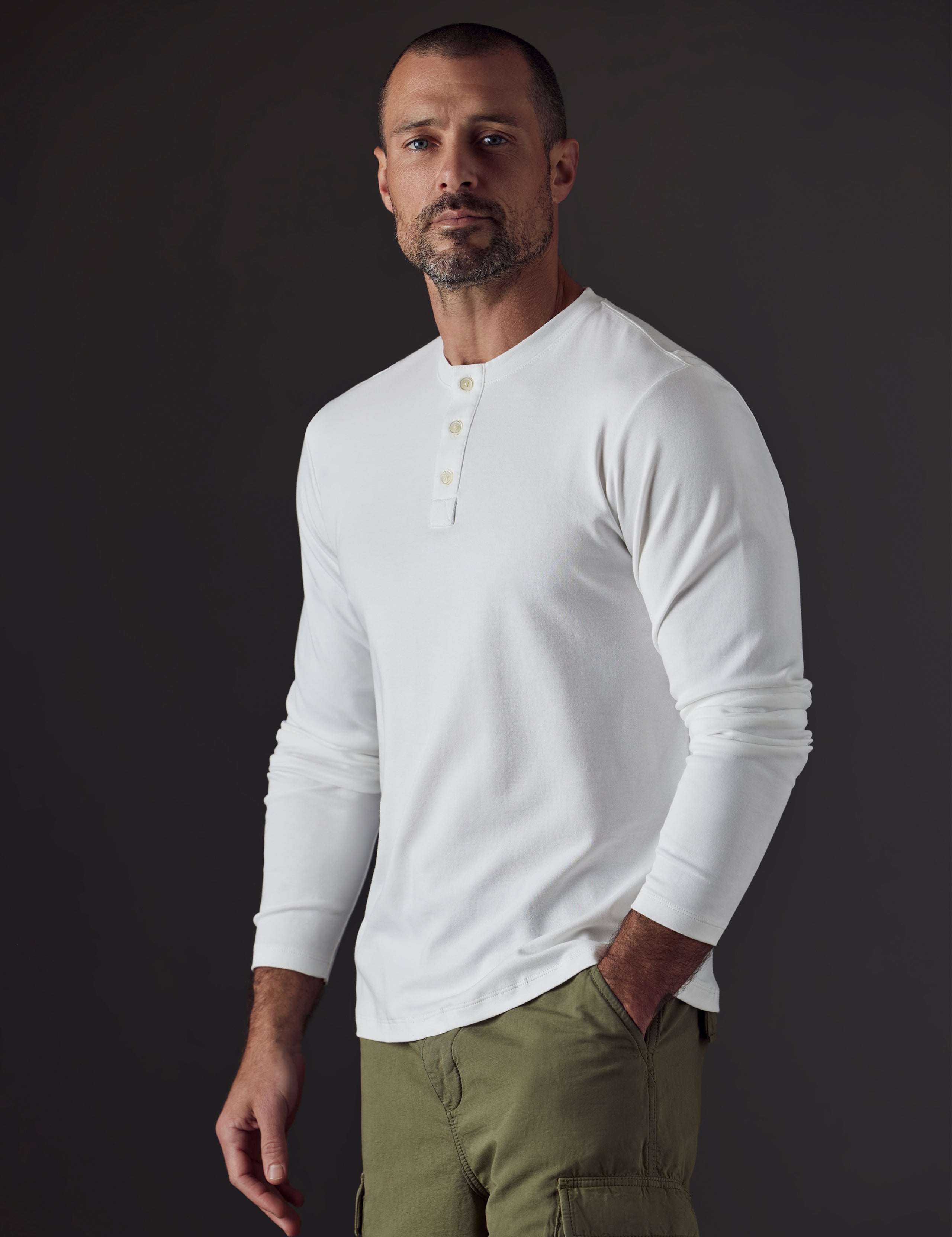 Man wearing white organic cotton henley from AETHER Apparel