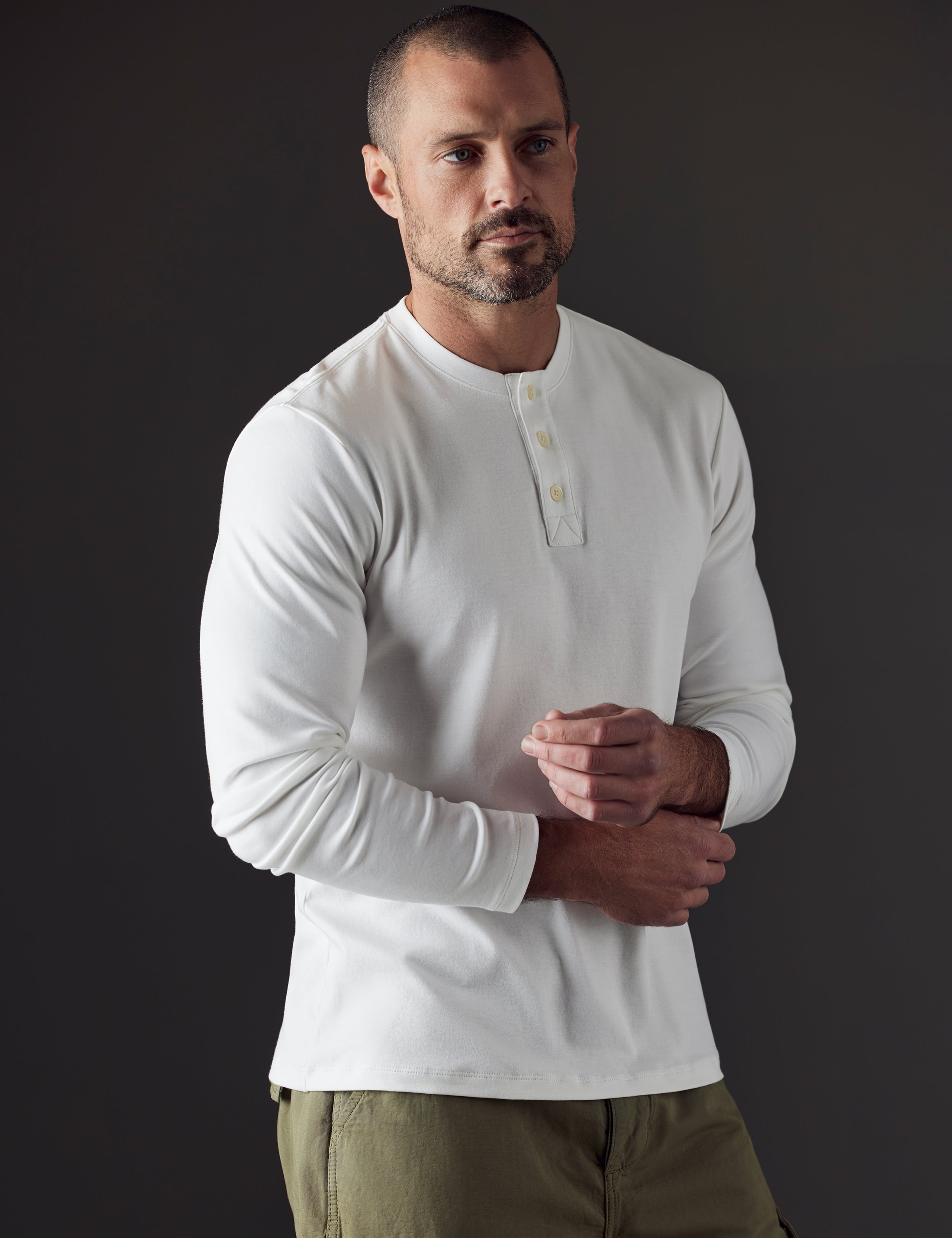 Man wearing white organic cotton henley from AETHER Apparel