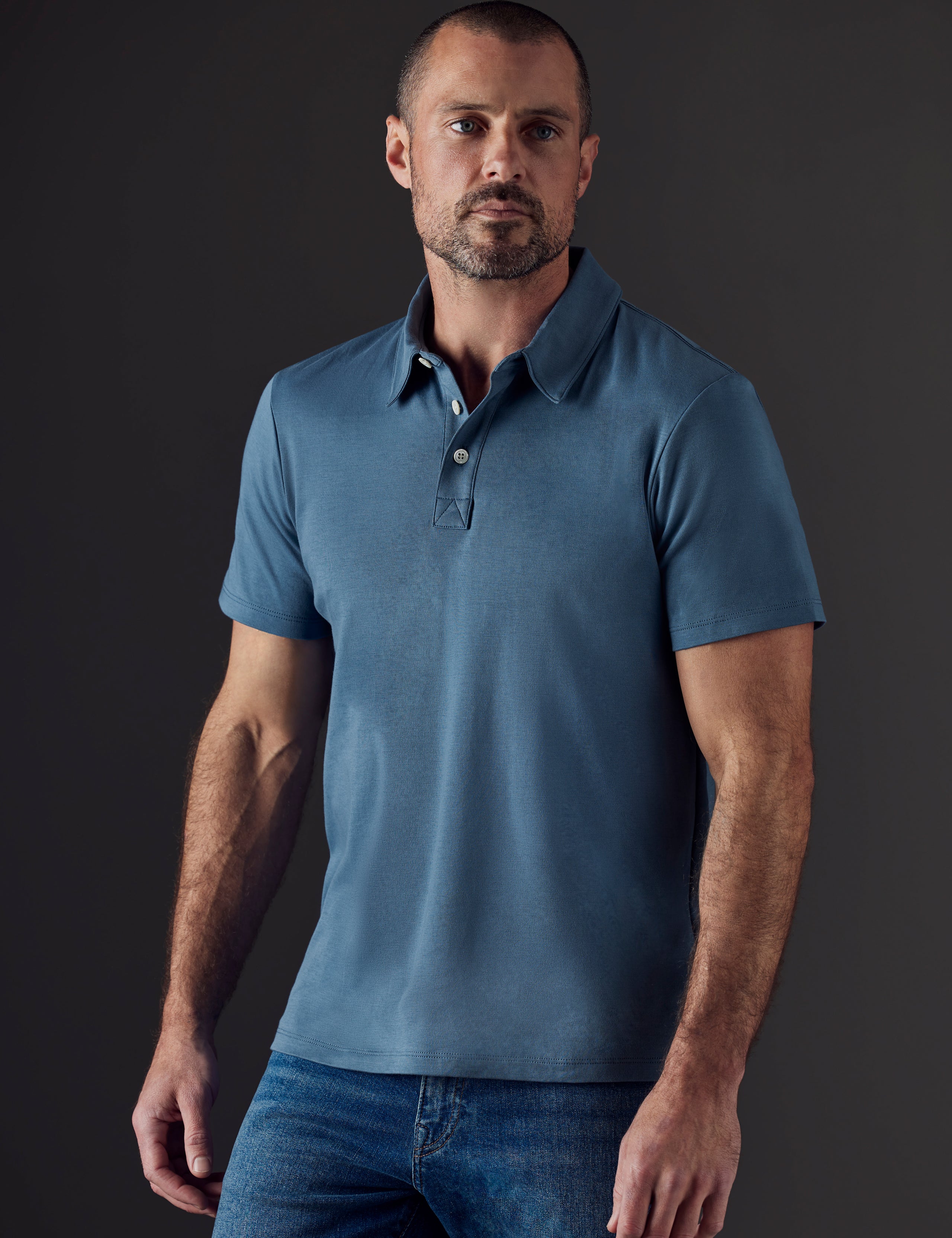 Man wearing blue organic cotton polo from AETHER Apparel