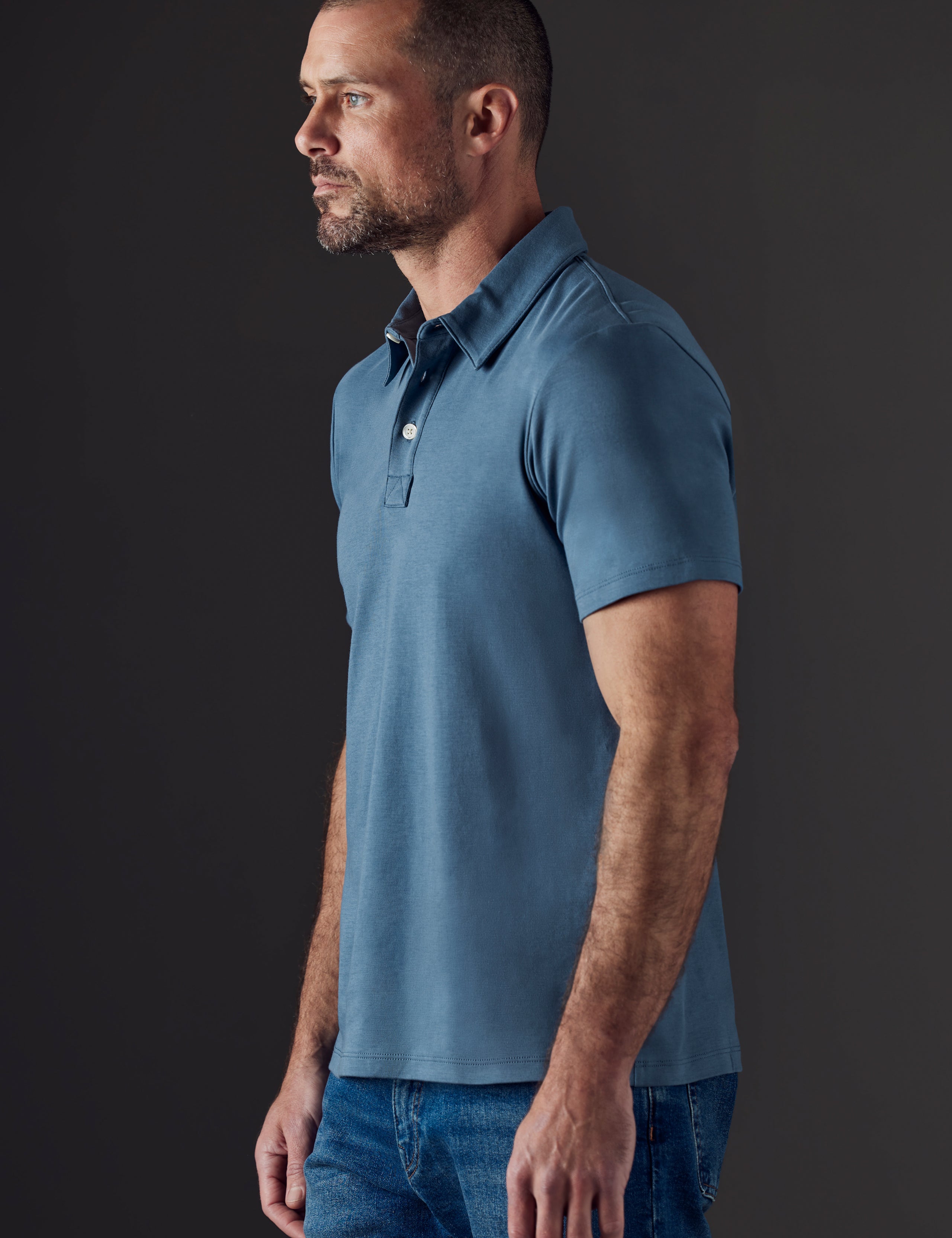 Man wearing blue organic cotton polo from AETHER Apparel