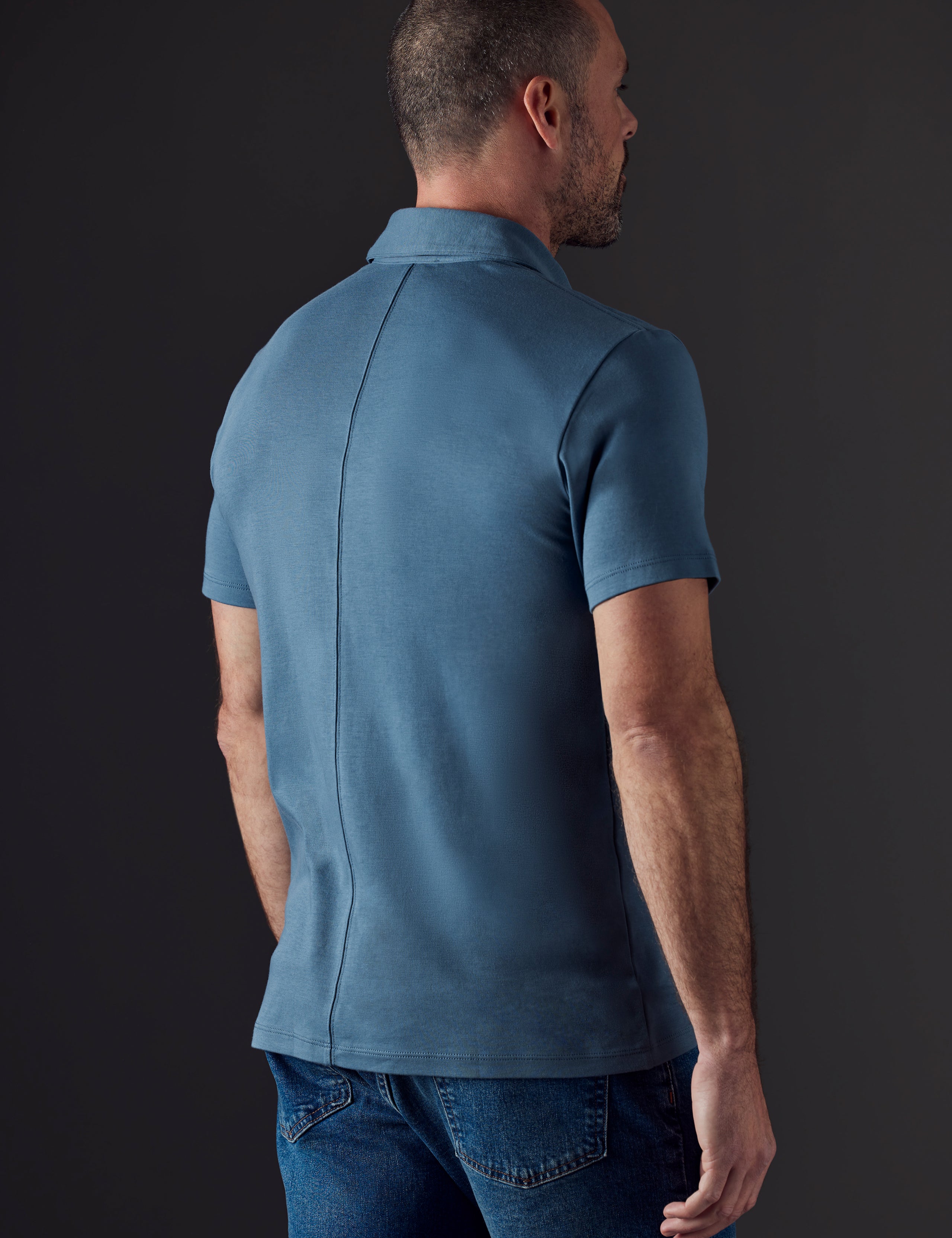 Man wearing blue organic cotton polo from AETHER Apparel