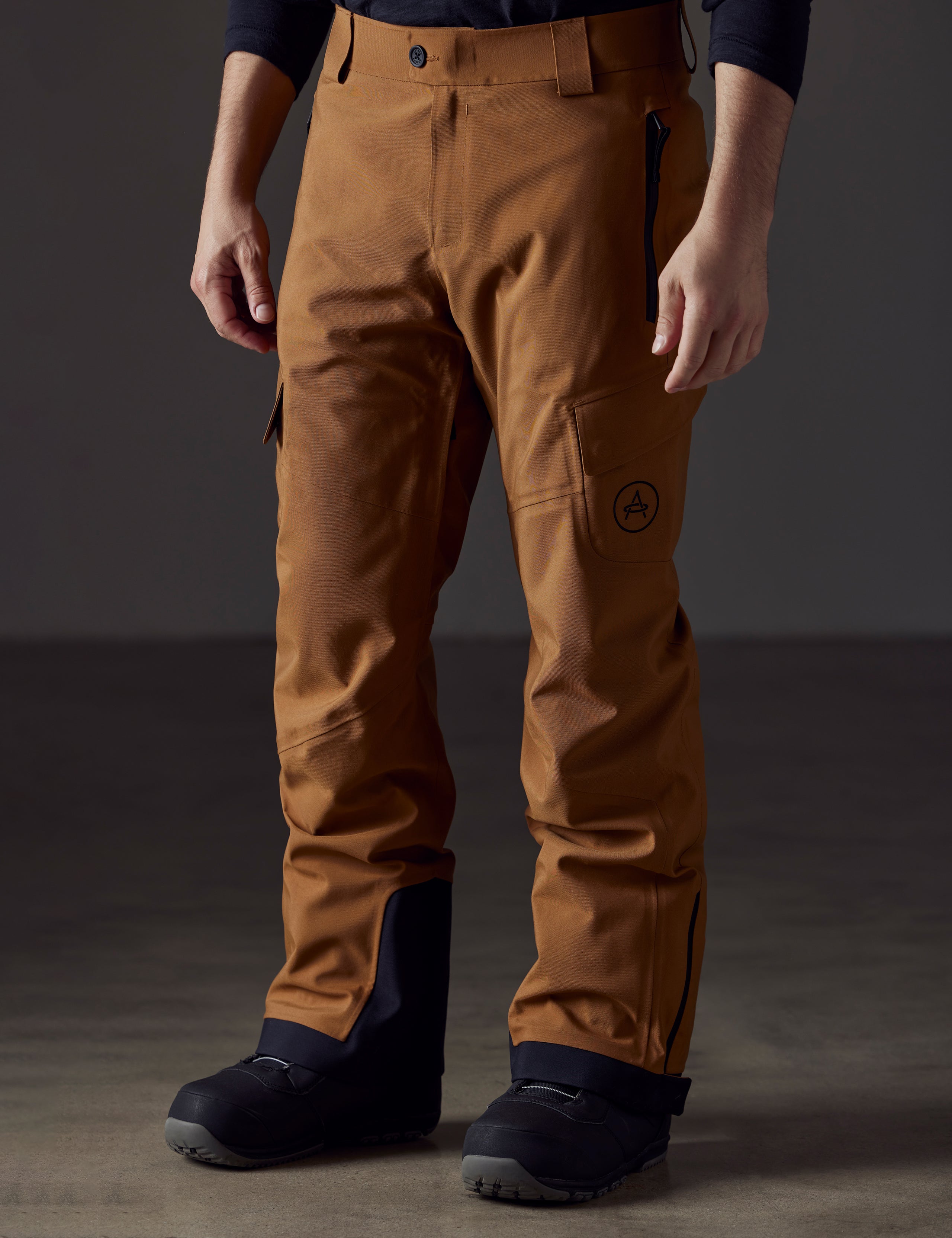 man wearing brown snow pants from AETHER Apparel