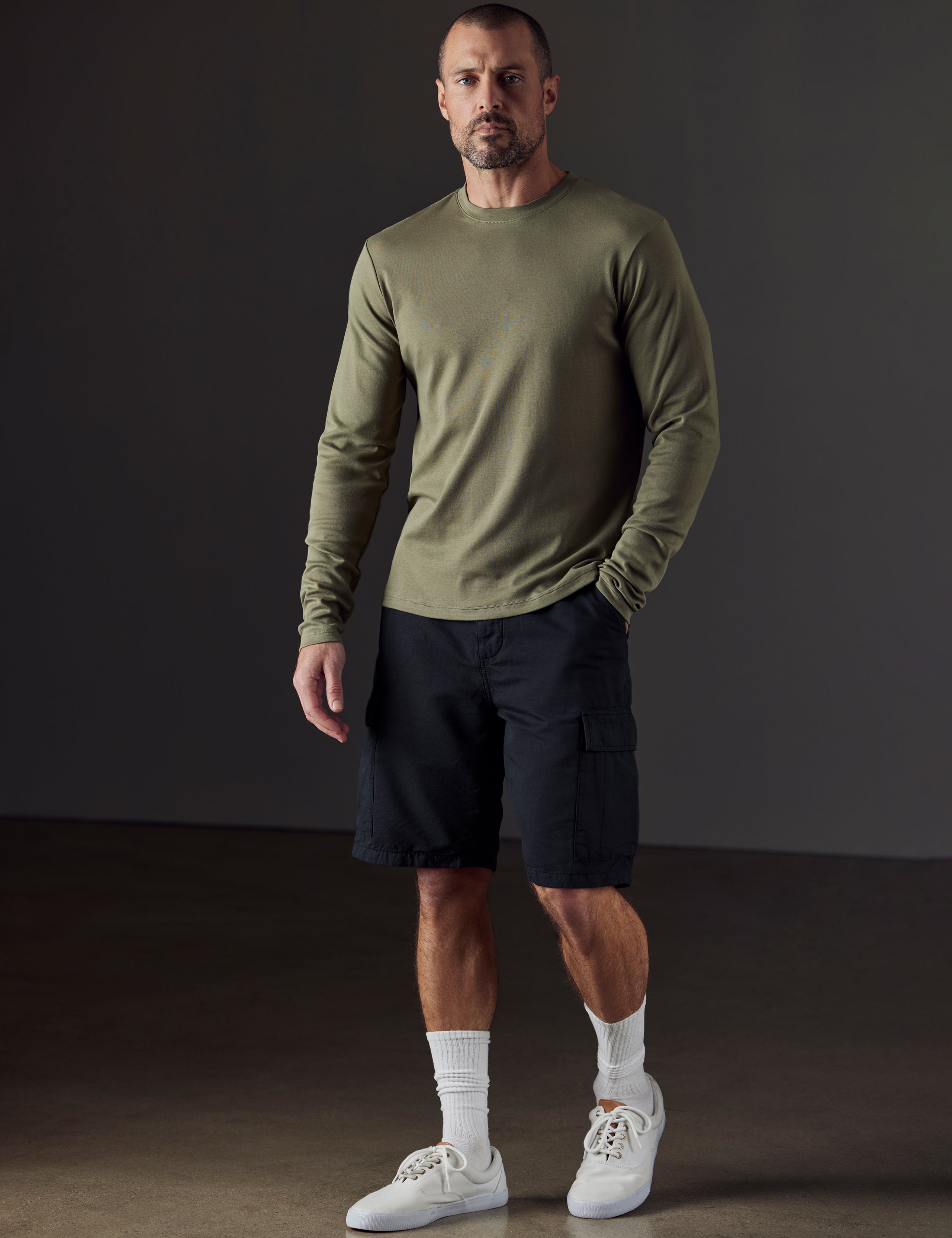man wearing black fatigue shorts from AETHER Apparel