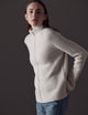 Woman wearing white sweater from AETHER Apparel