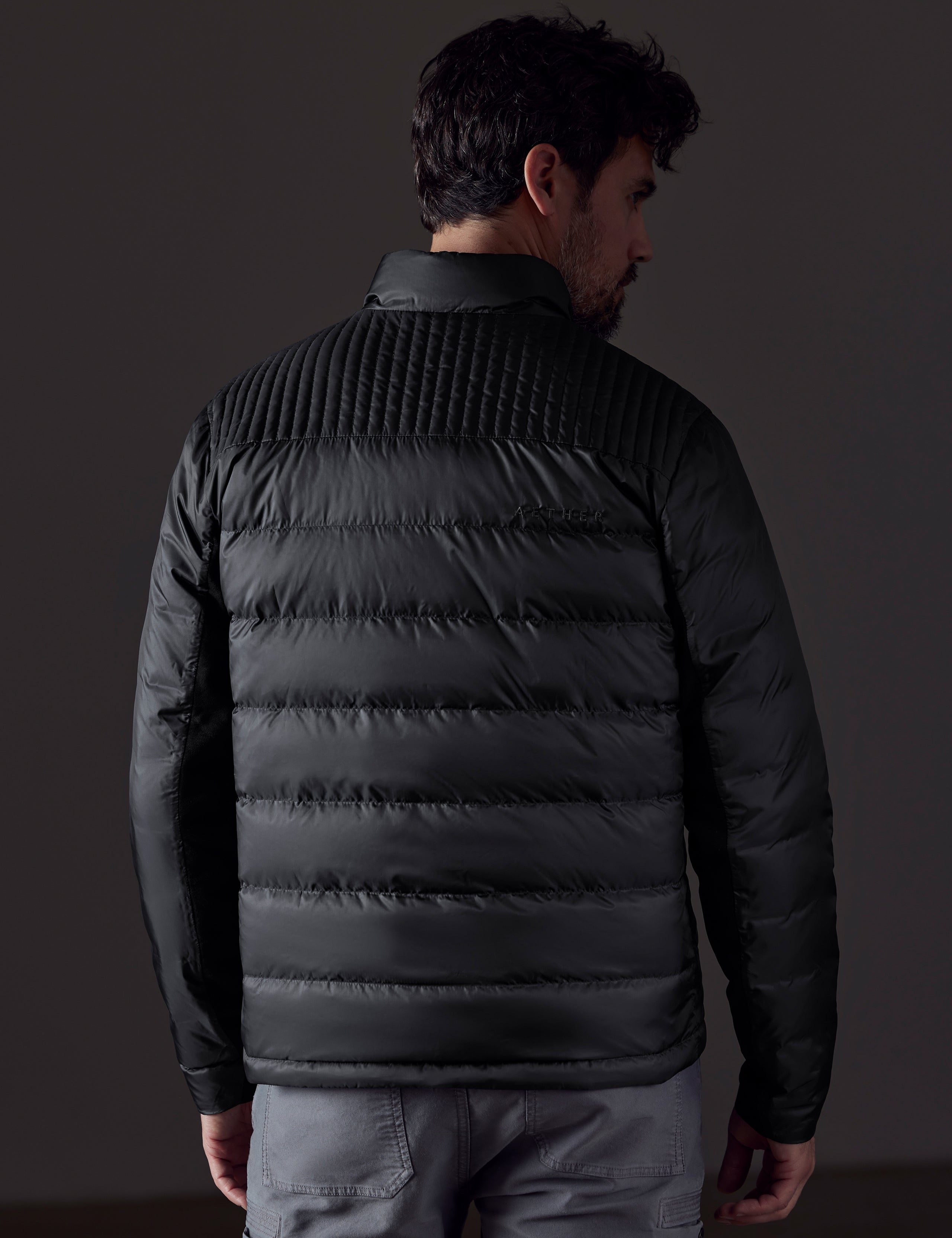 man wearing a black insulated jacket from AETHER Apparel