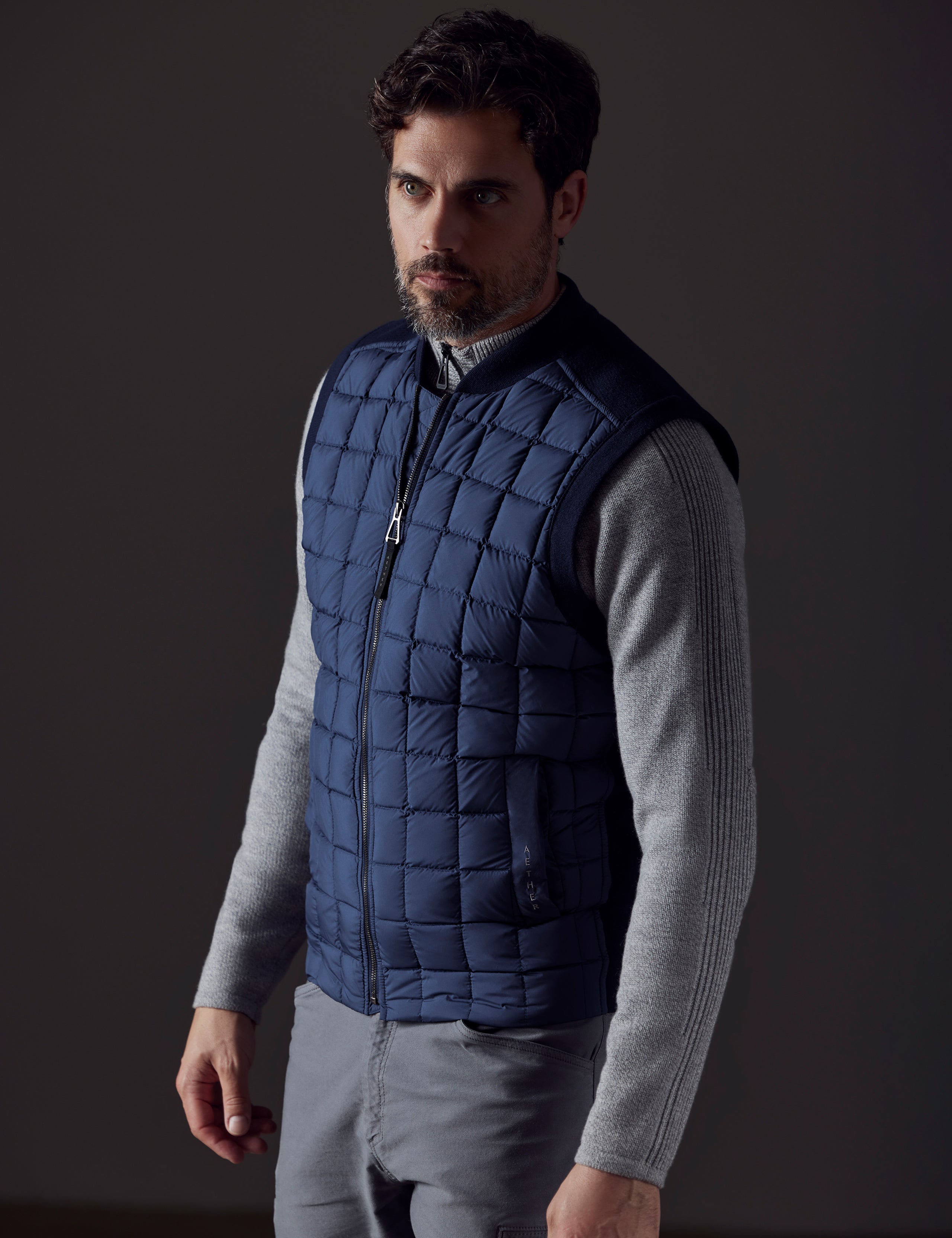 man wearing blue insulated vest from AETHER Apparel