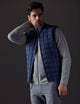 man wearing blue insulated vest from AETHER Apparel