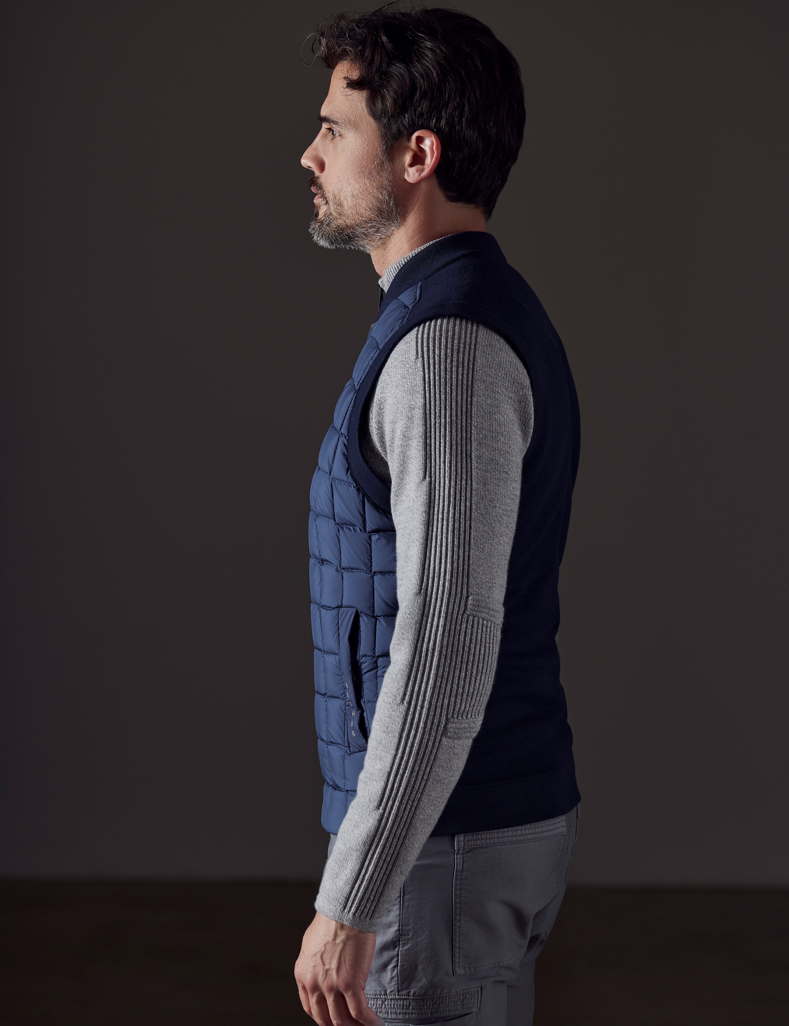 man wearing blue insulated vest from AETHER Apparel