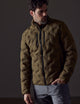 Man wearing green insulated jacket from AETHER Apparel