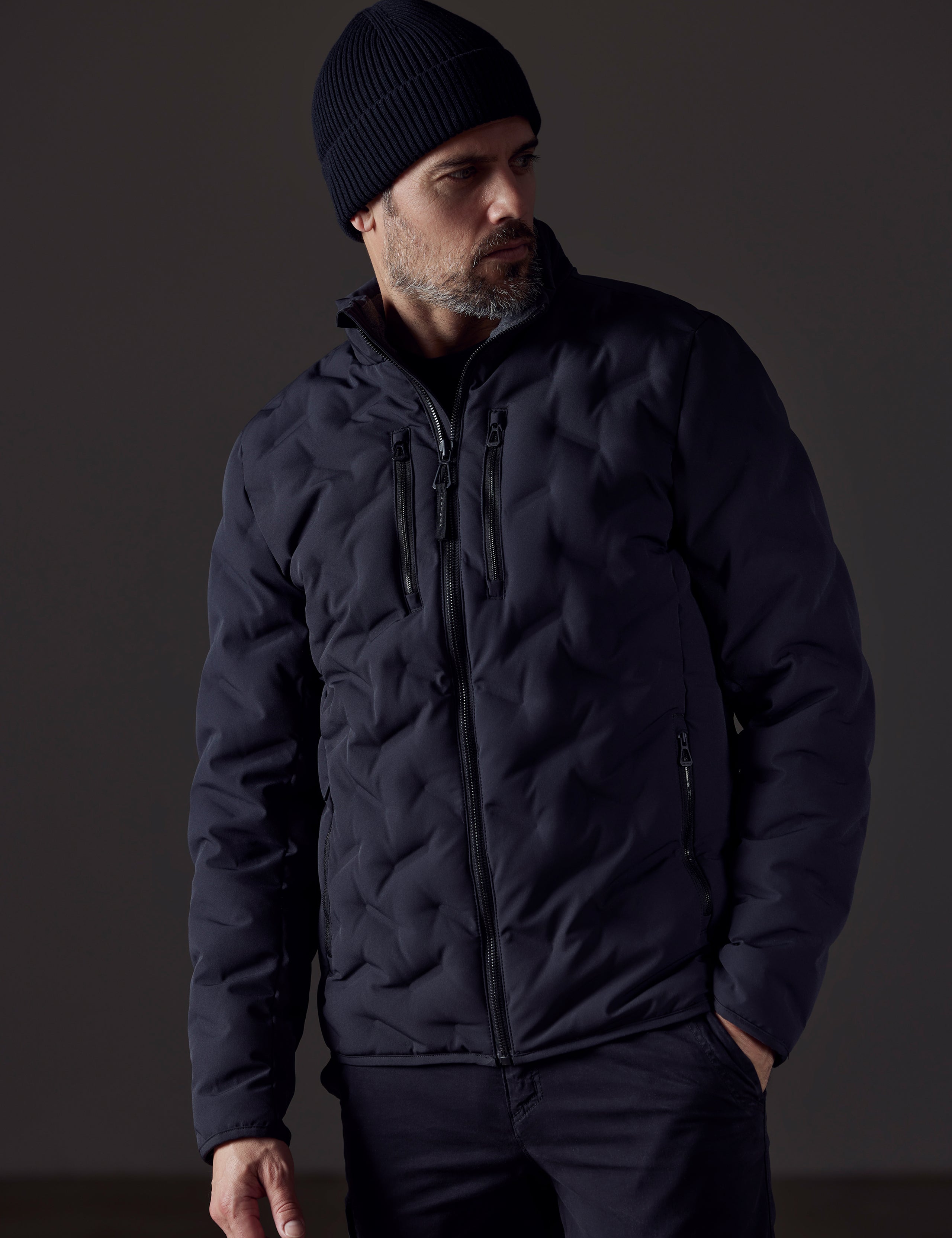 Man wearing black insulated jacket from AETHER Apparel