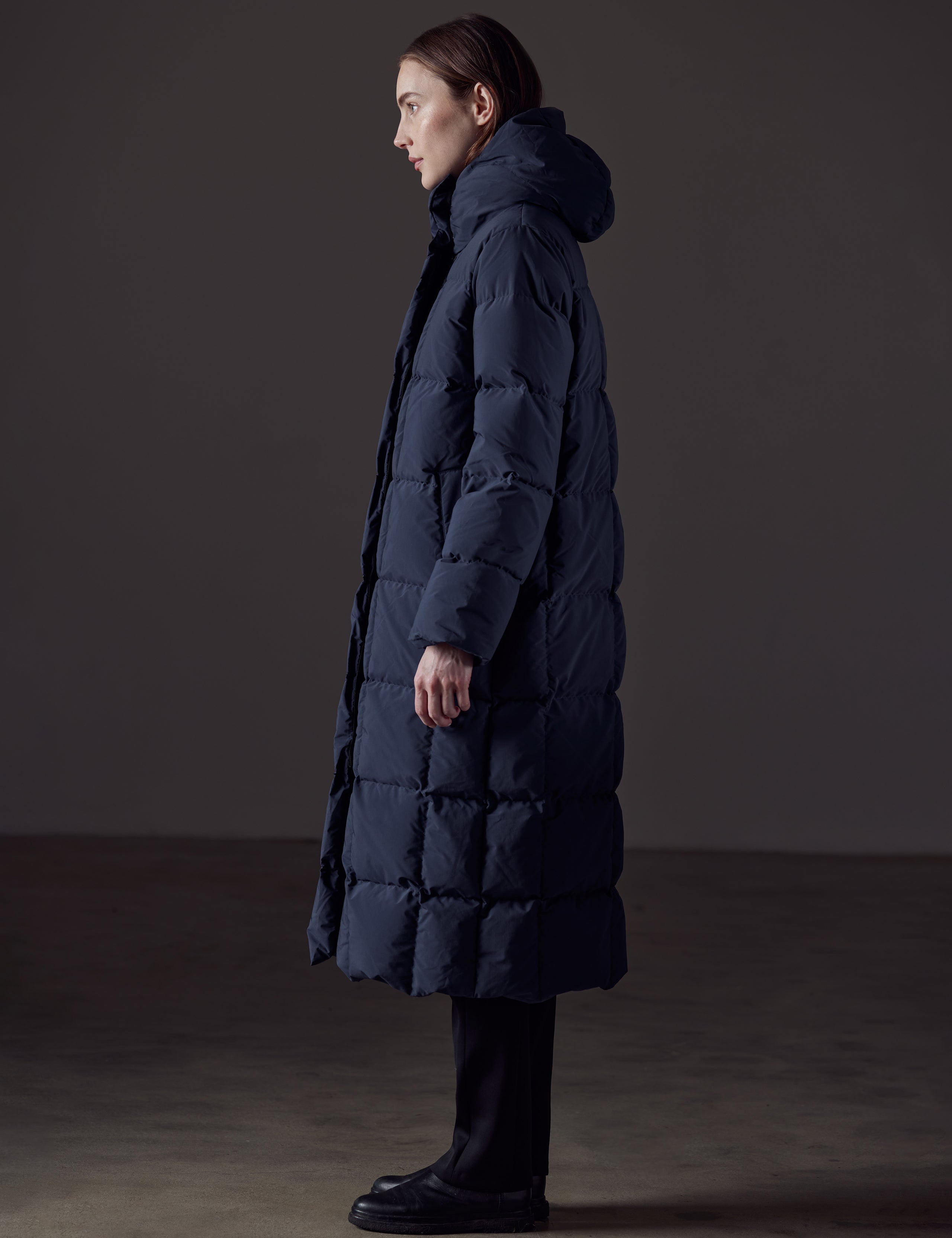 Woman wearing blue winter jacket from AETHER Apparel 