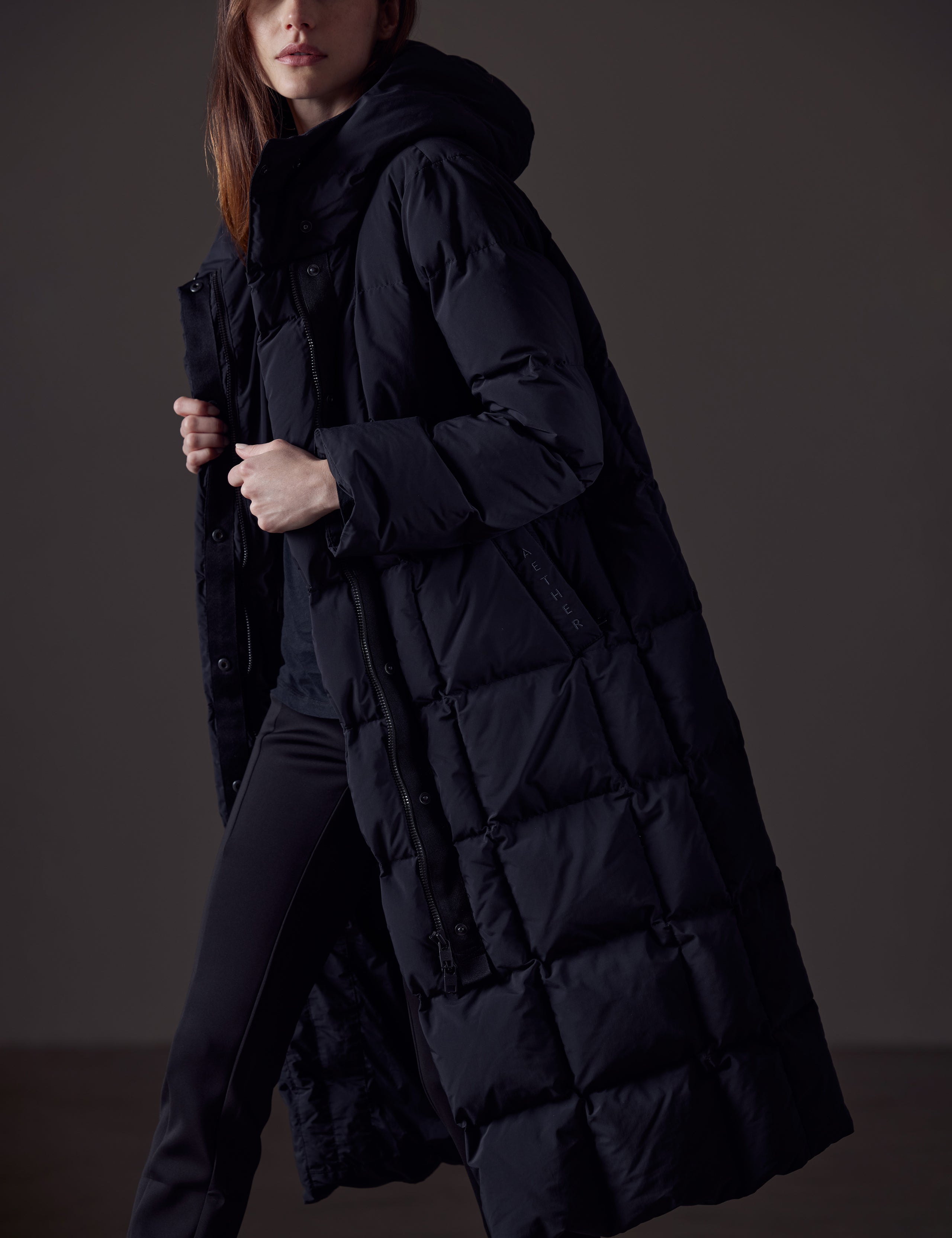 Woman wearing black winter jacket from AETHER Apparel 