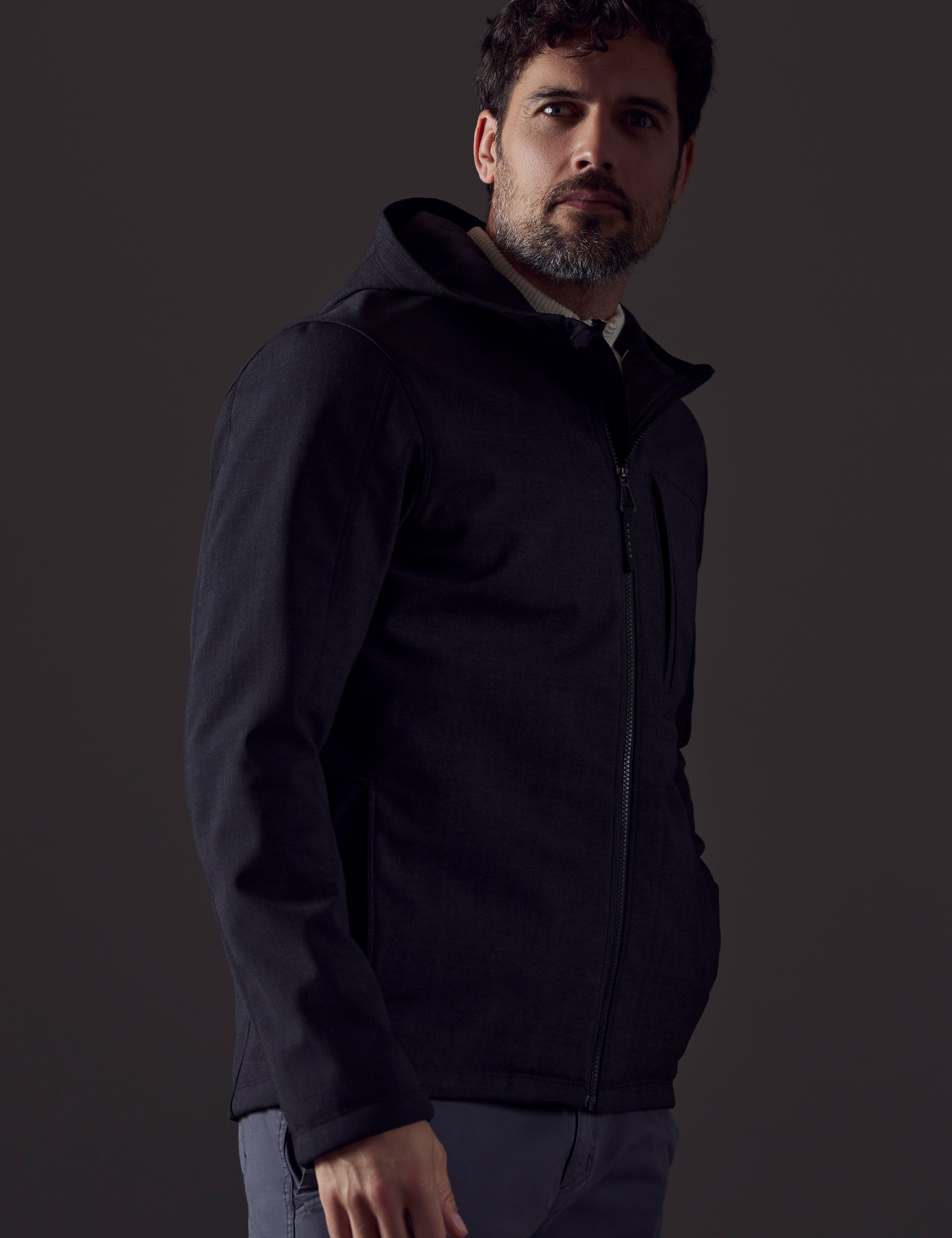 Man wearing dark grey technical jacket from AETHER Apparel