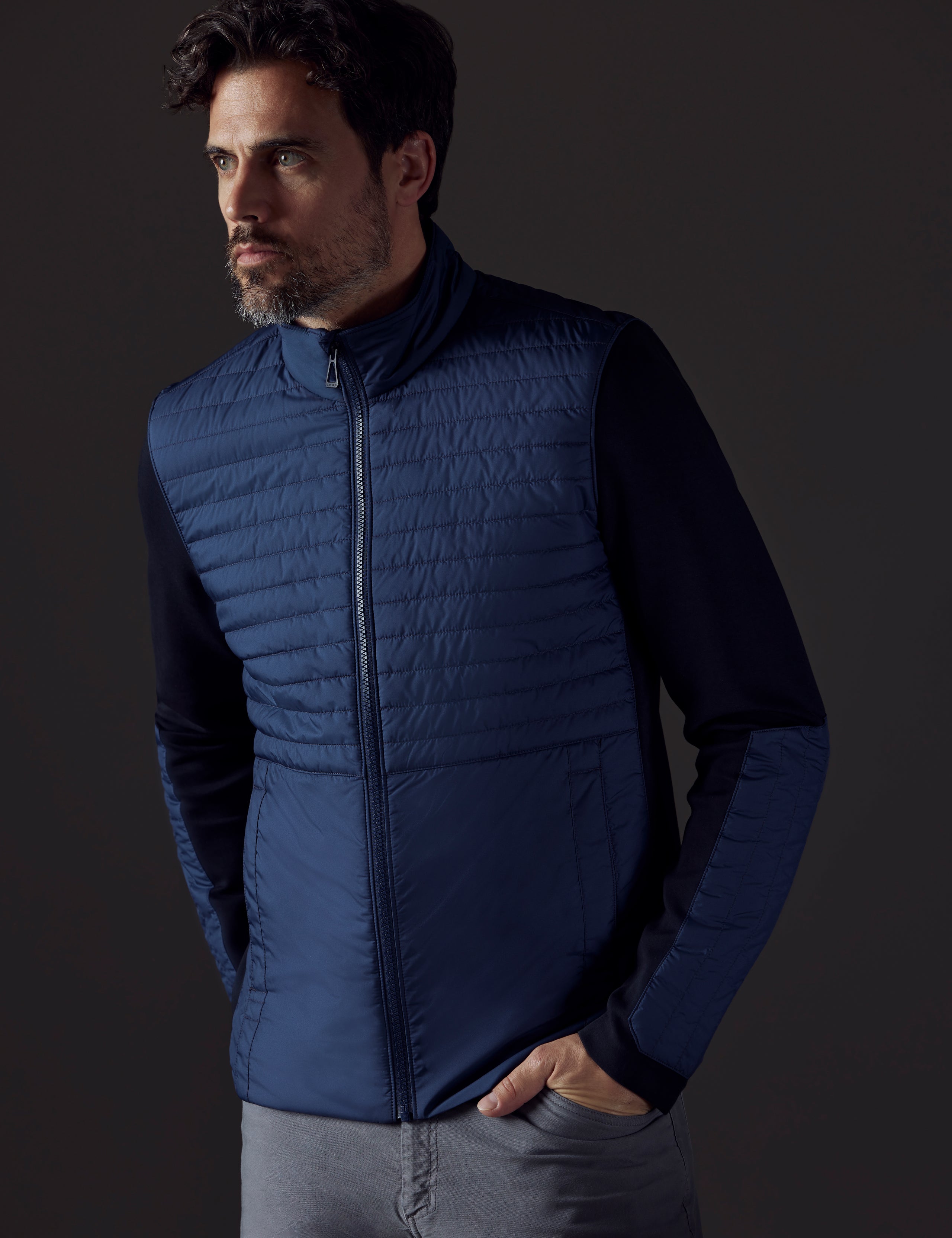 Man wearing blue technical jacket from AETHER Apparel