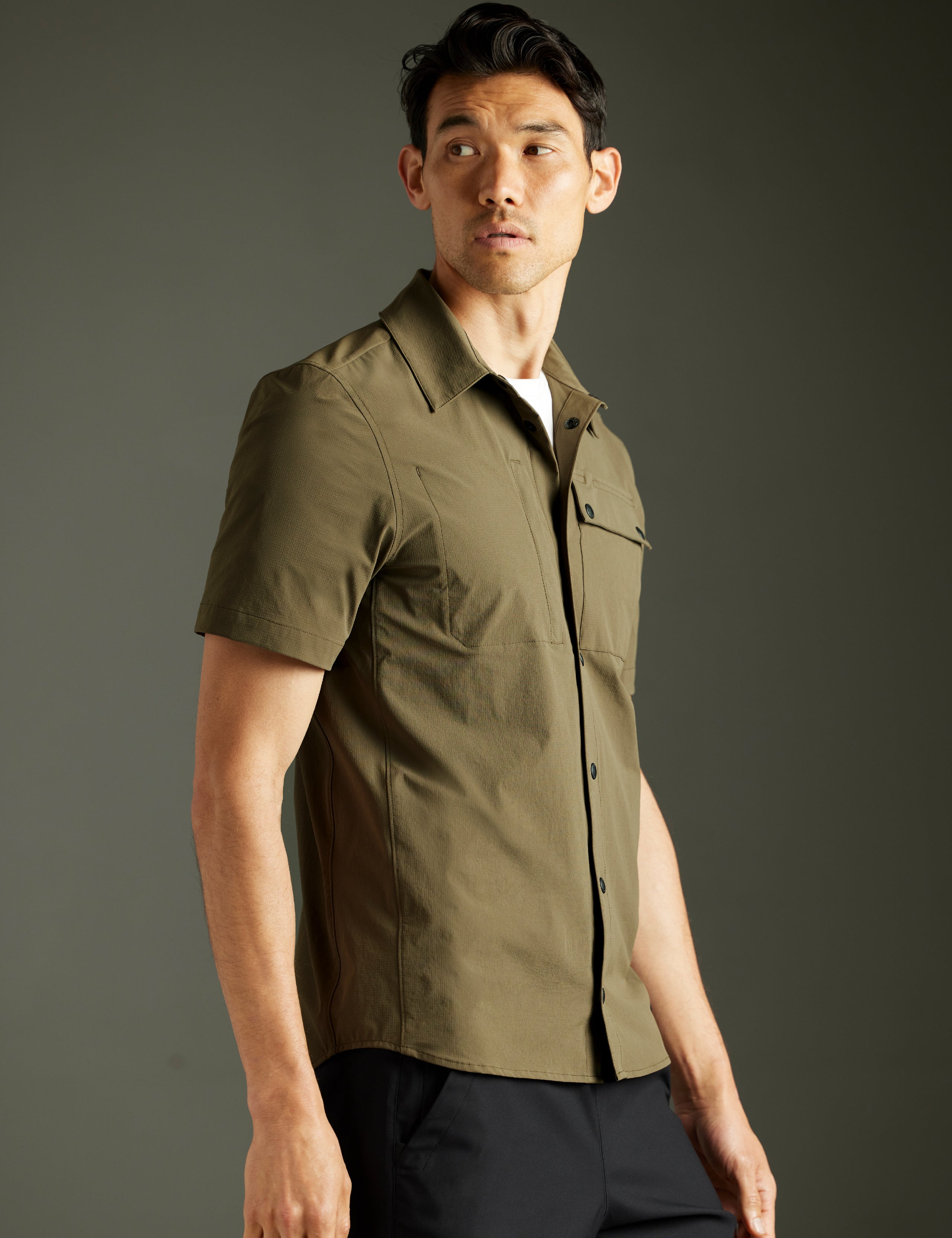 man wearing green short-sleeve button down from AETHER Apparel