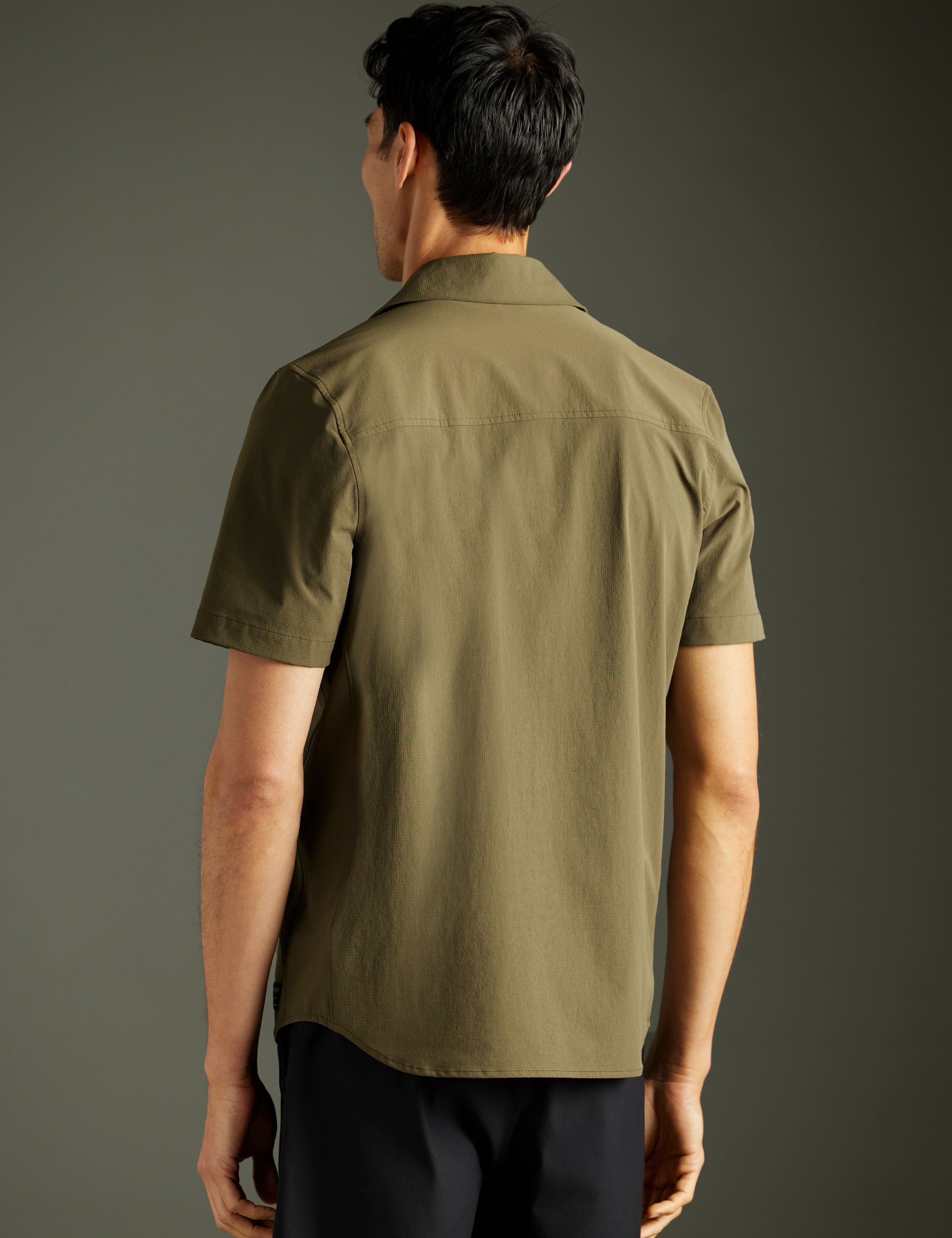 man wearing green short-sleeve button down from AETHER Apparel