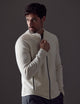 Man wearing white Riley Full-Zip Sweater from AETHER Apparel