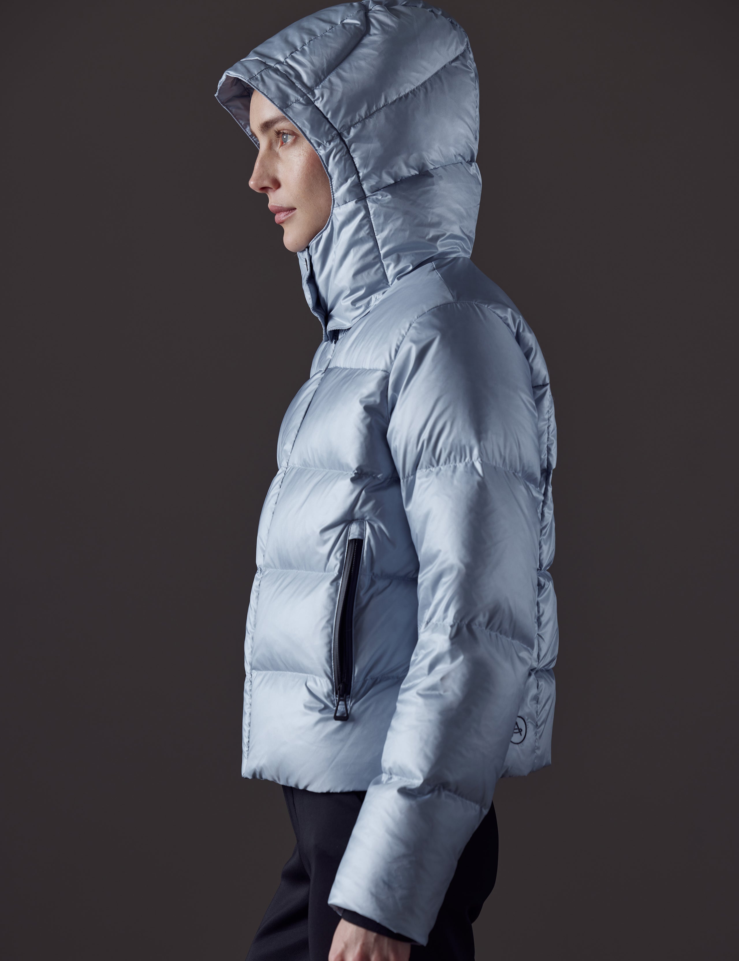 Woman wearing blue puffer jacket from AETHER Apparel