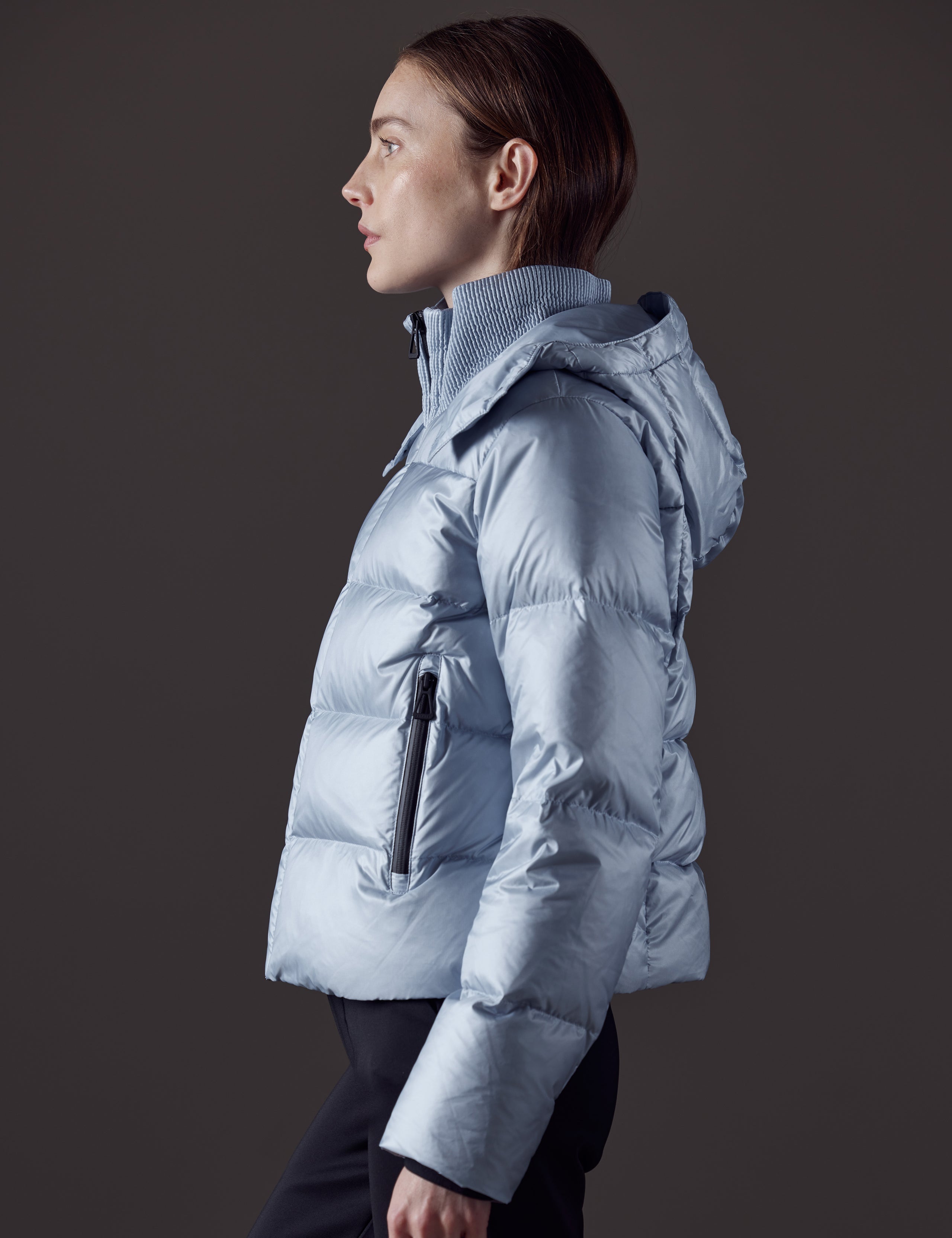 Woman wearing blue puffer jacket from AETHER Apparel