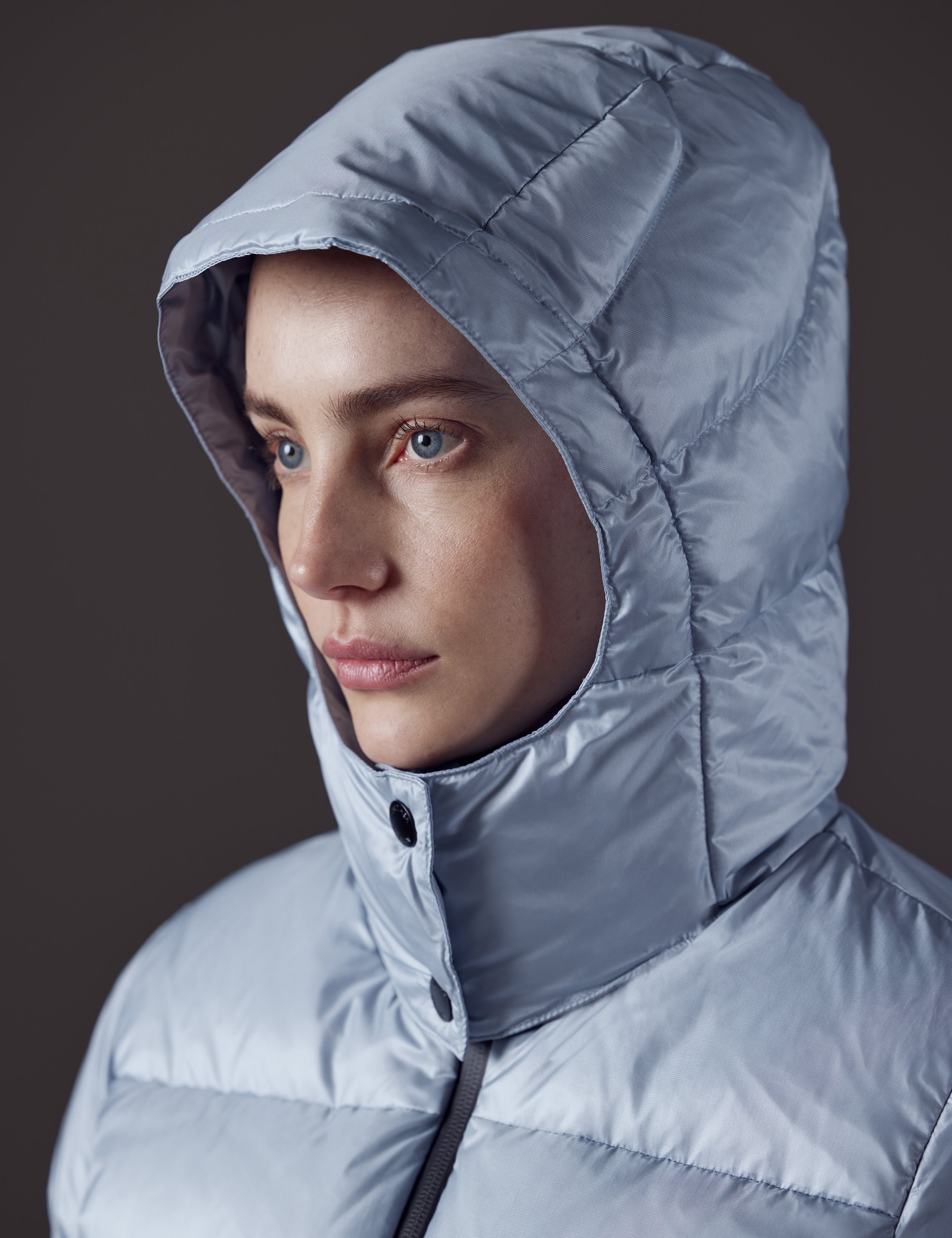 Woman wearing blue puffer jacket from AETHER Apparel