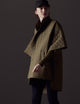 Woman wearing green Bardo Poncho Jacket from AETHER Apparel