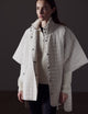 Woman wearing beige Bardo Poncho Jacket from AETHER Apparel