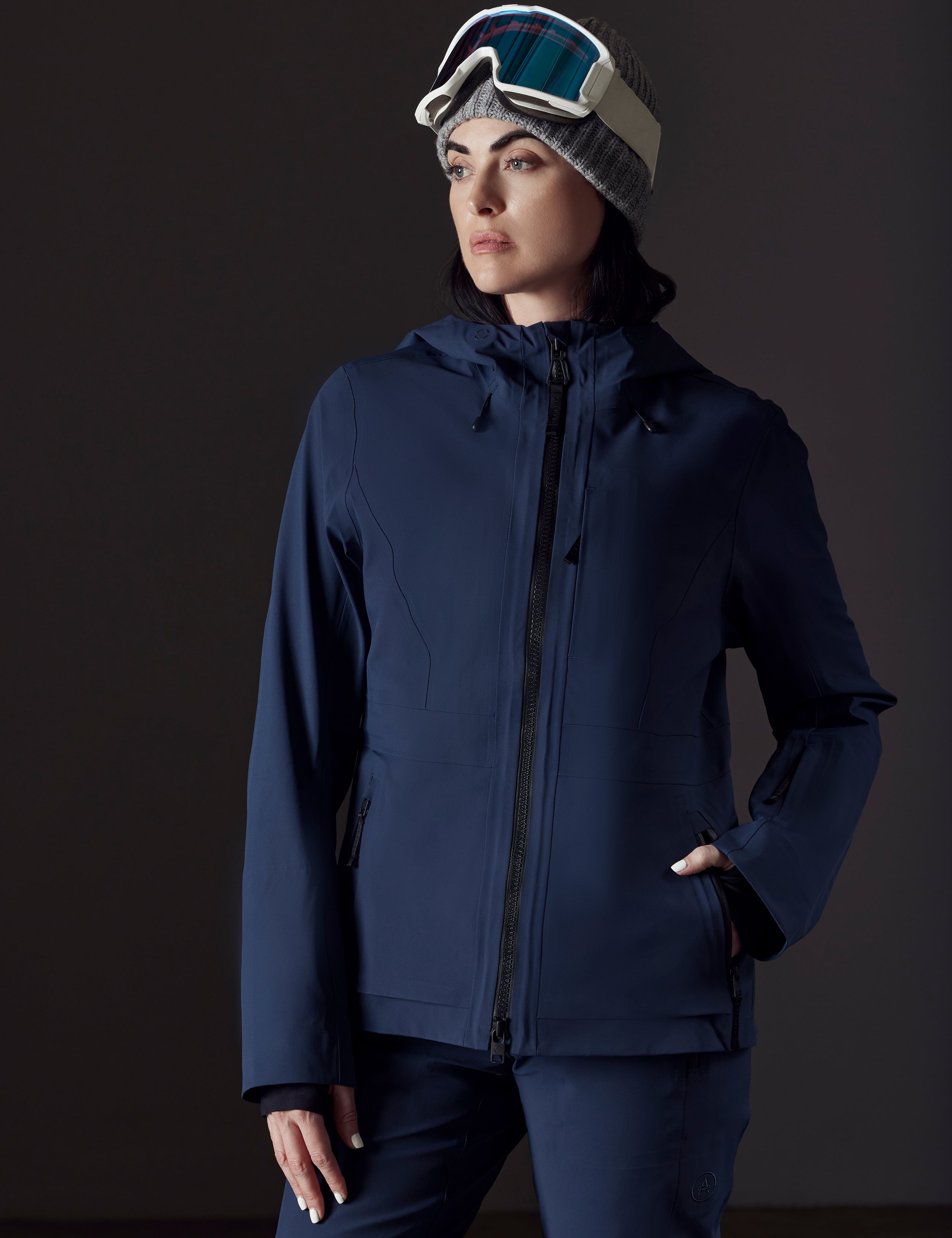 woman wearing dark blue snow jacket from AETHER Apparel