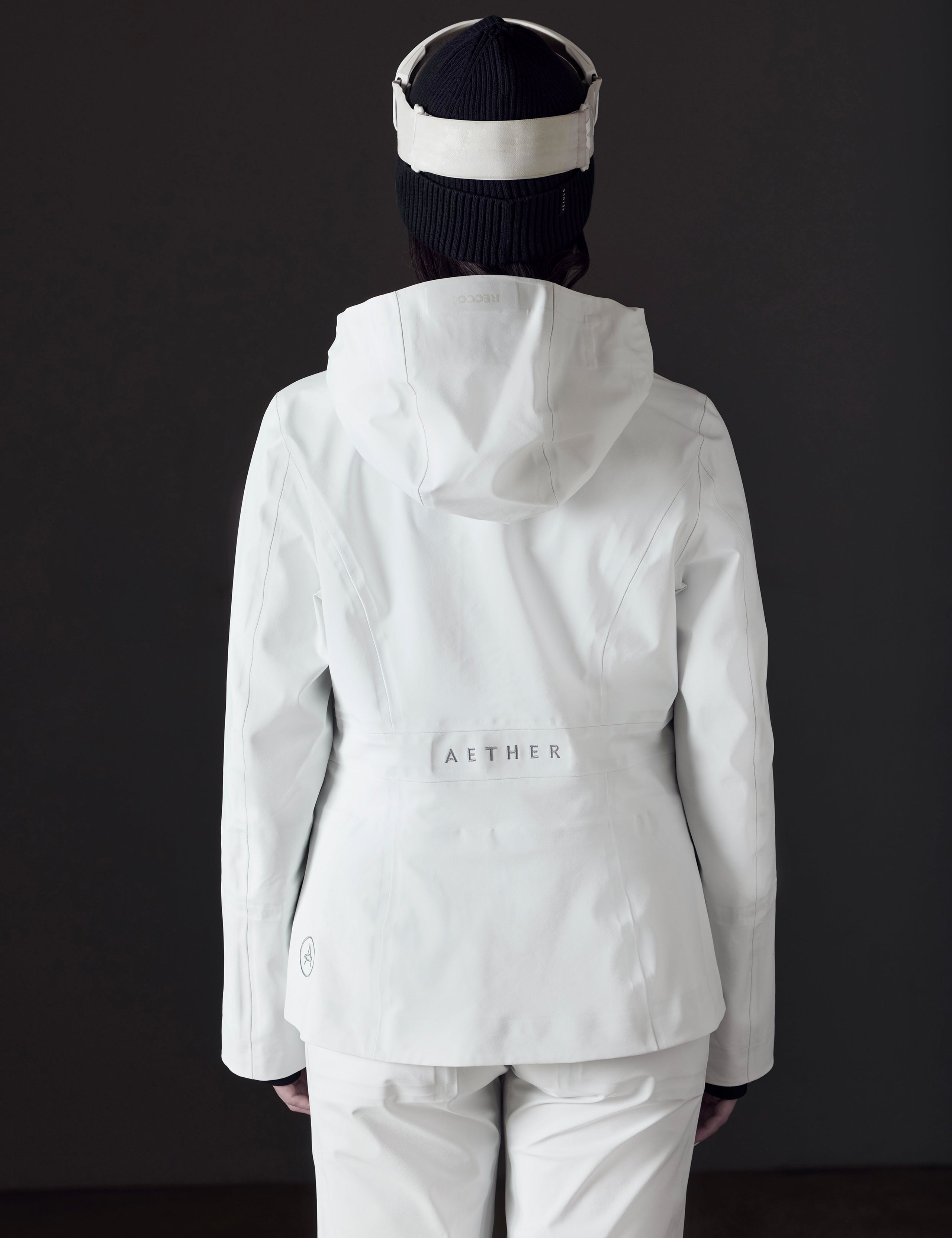 woman wearing white snow jacket from AETHER Apparel