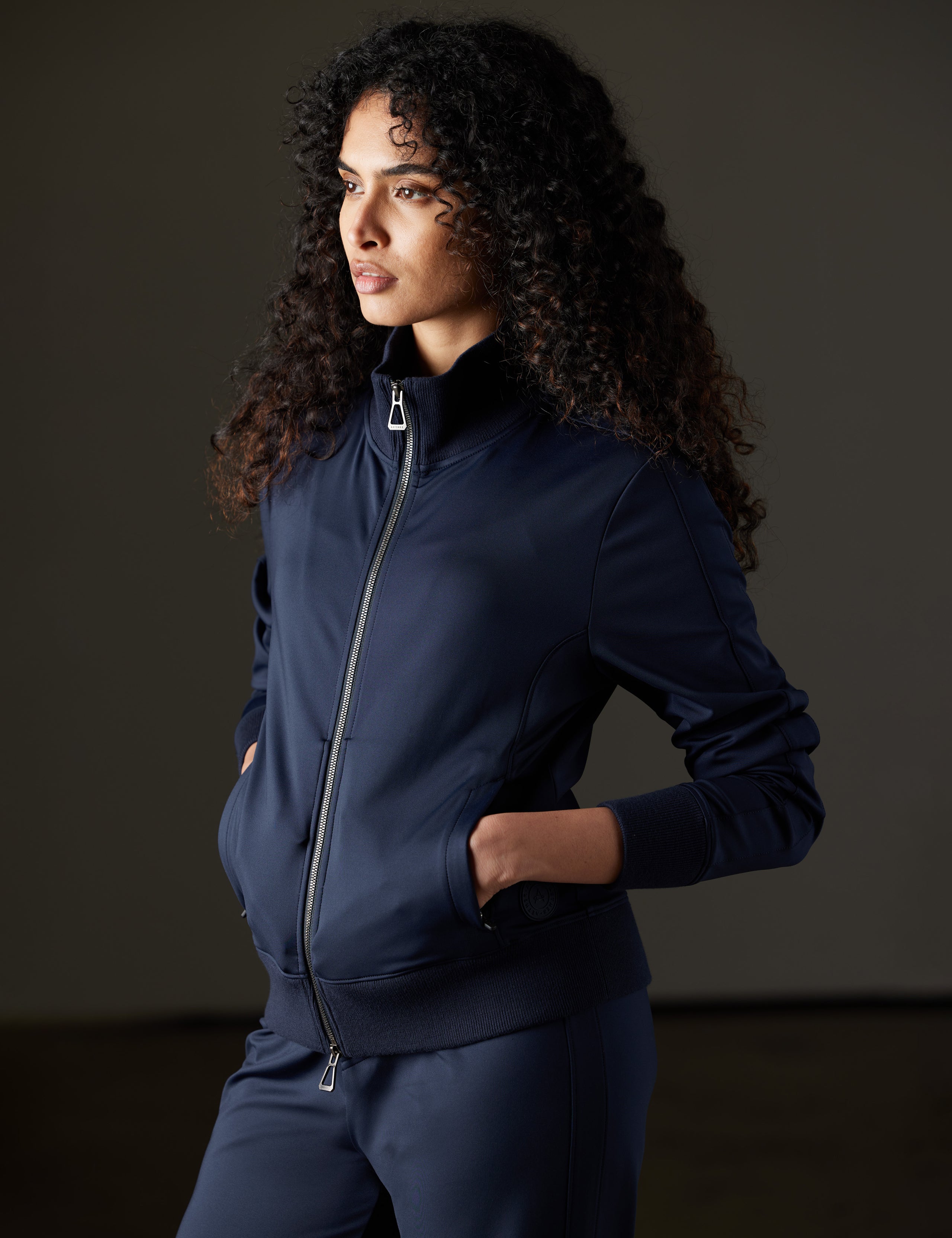 Woman wearing blue jacket from AETHER Apparel