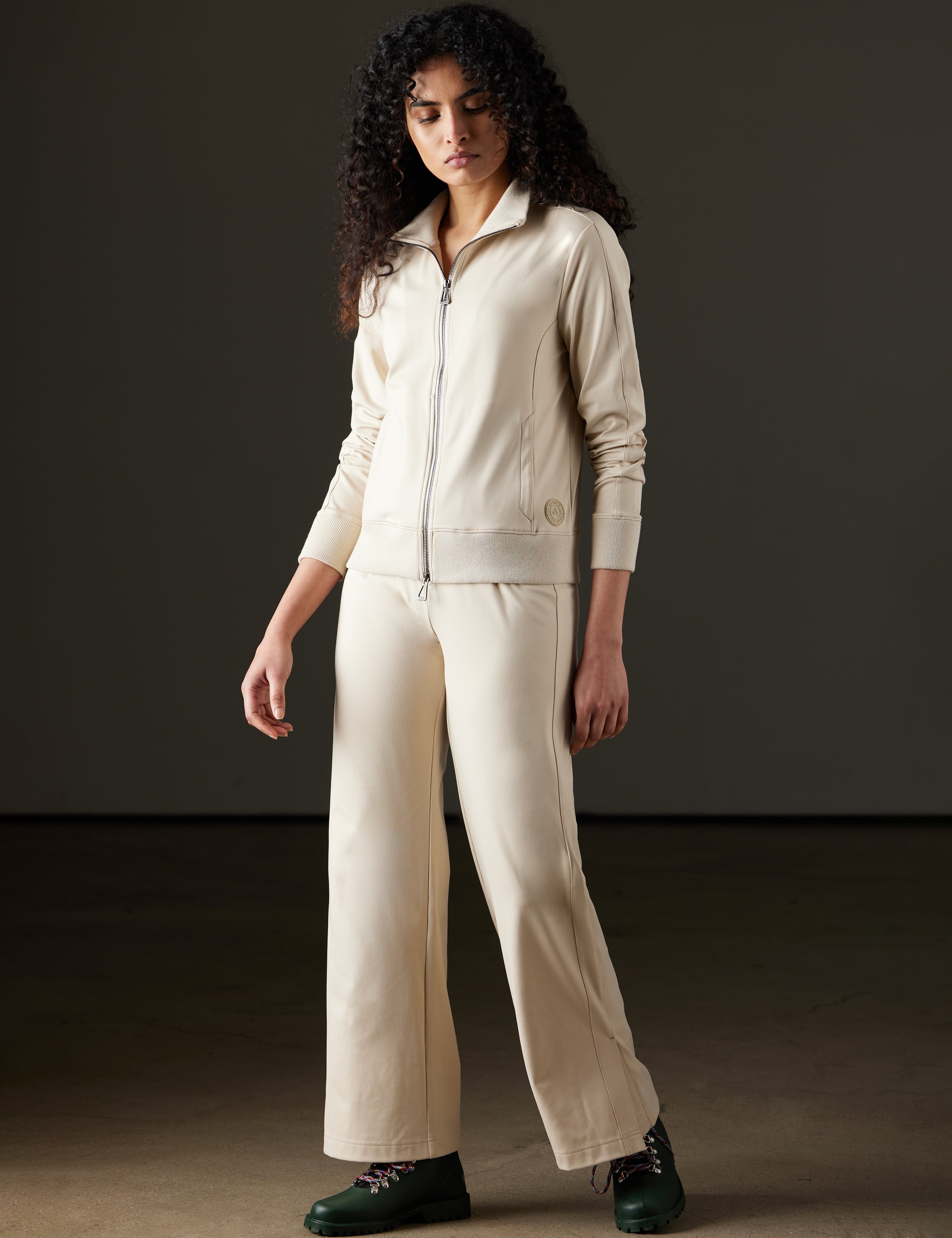 Woman wearing white travel pant from AETHER Apparel