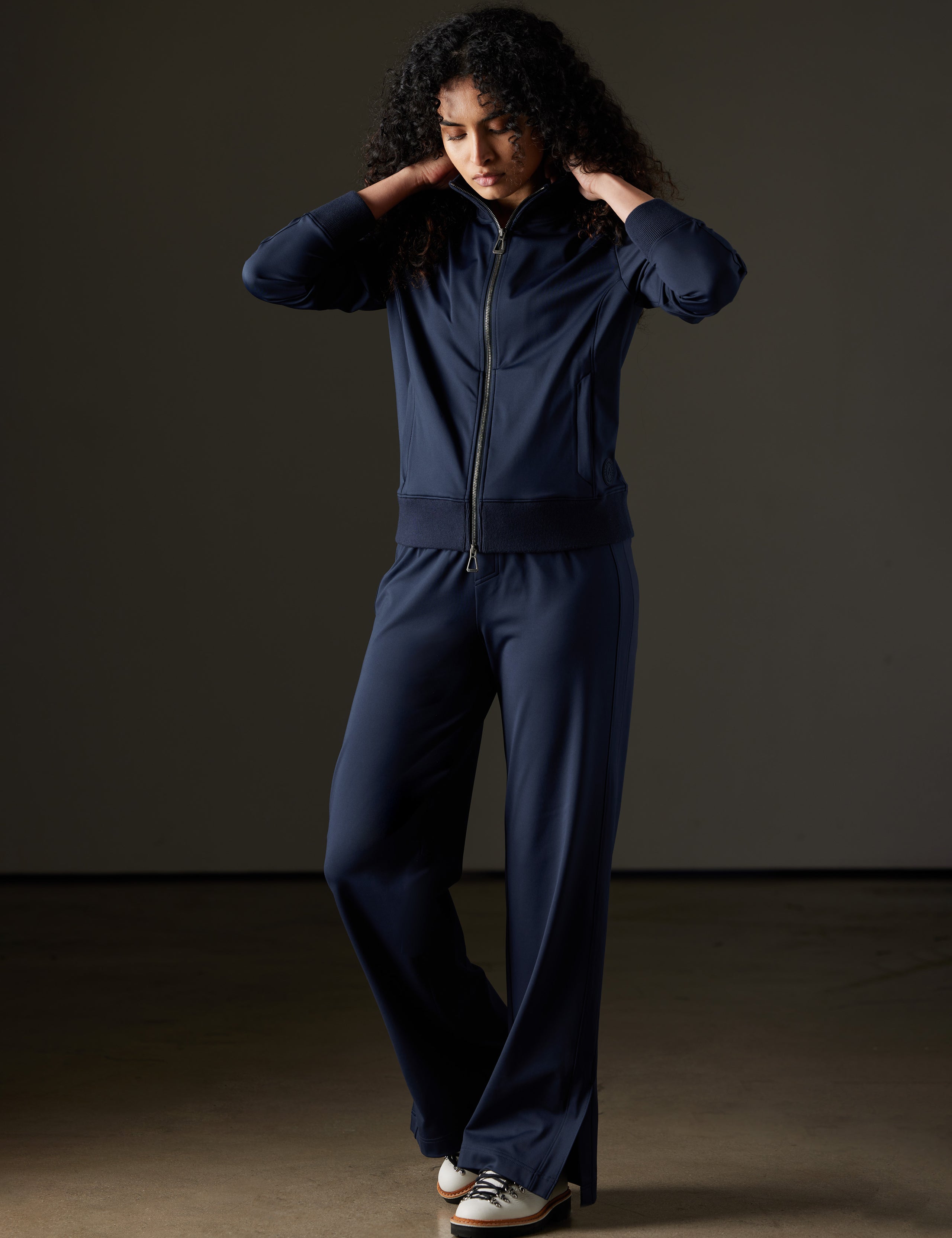 Woman wearing blue travel pant from AETHER Apparel