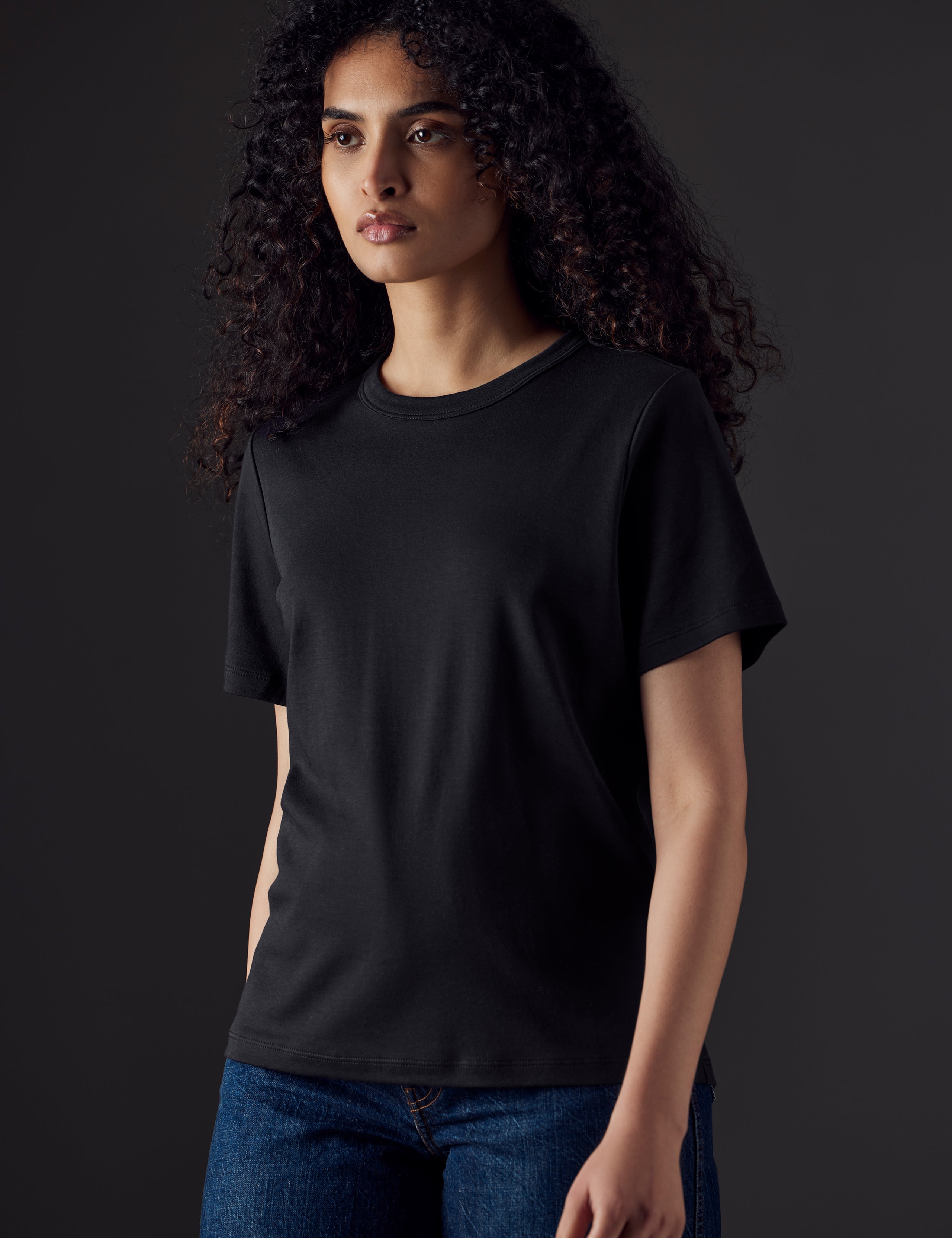 Woman wearing black organic tee from AETHER Apparel