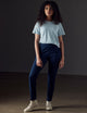 Woman wearing blue organic cropped tee from AETHER Apparel