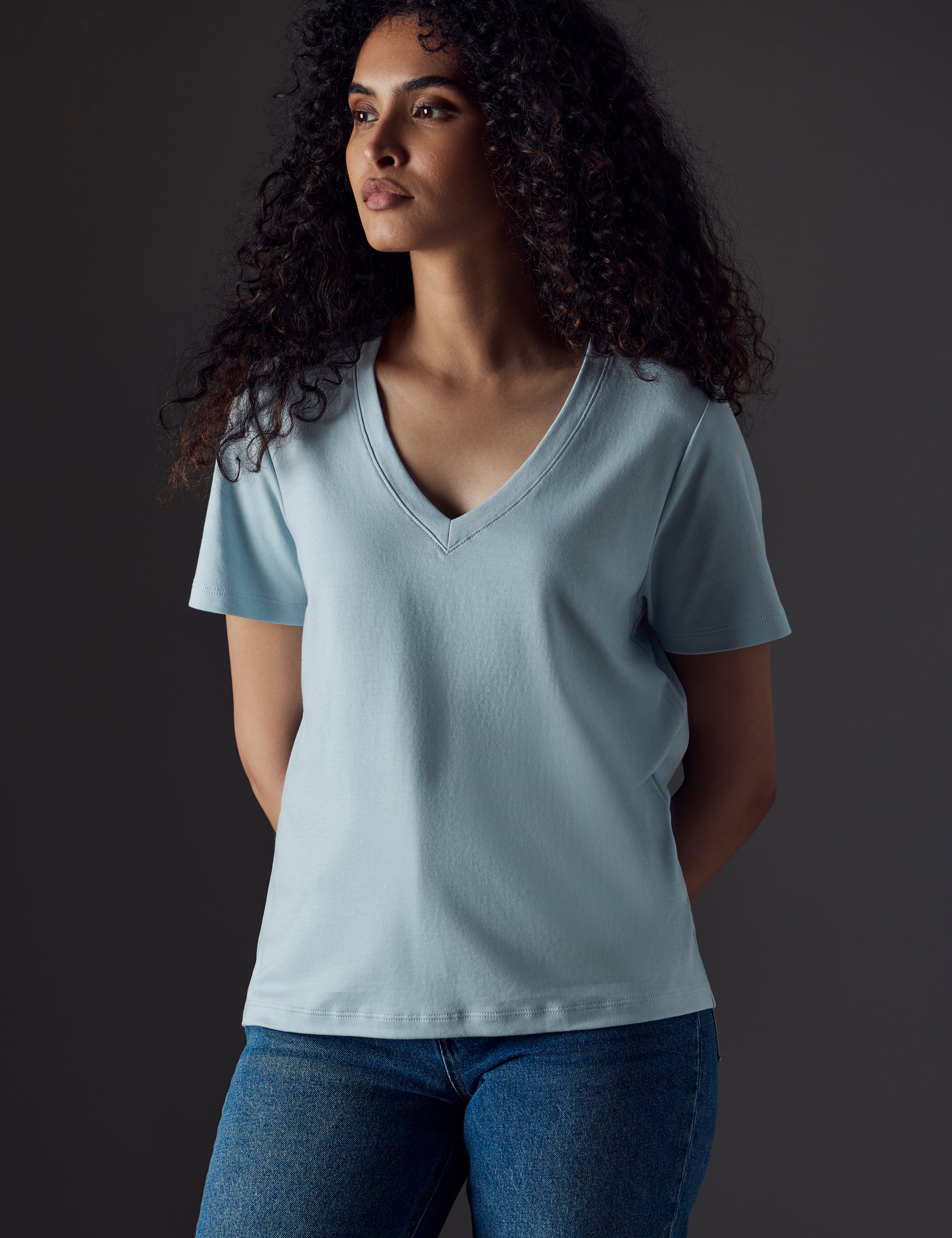 Woman wearing blue organic cotton v neck from AETHER Apparel