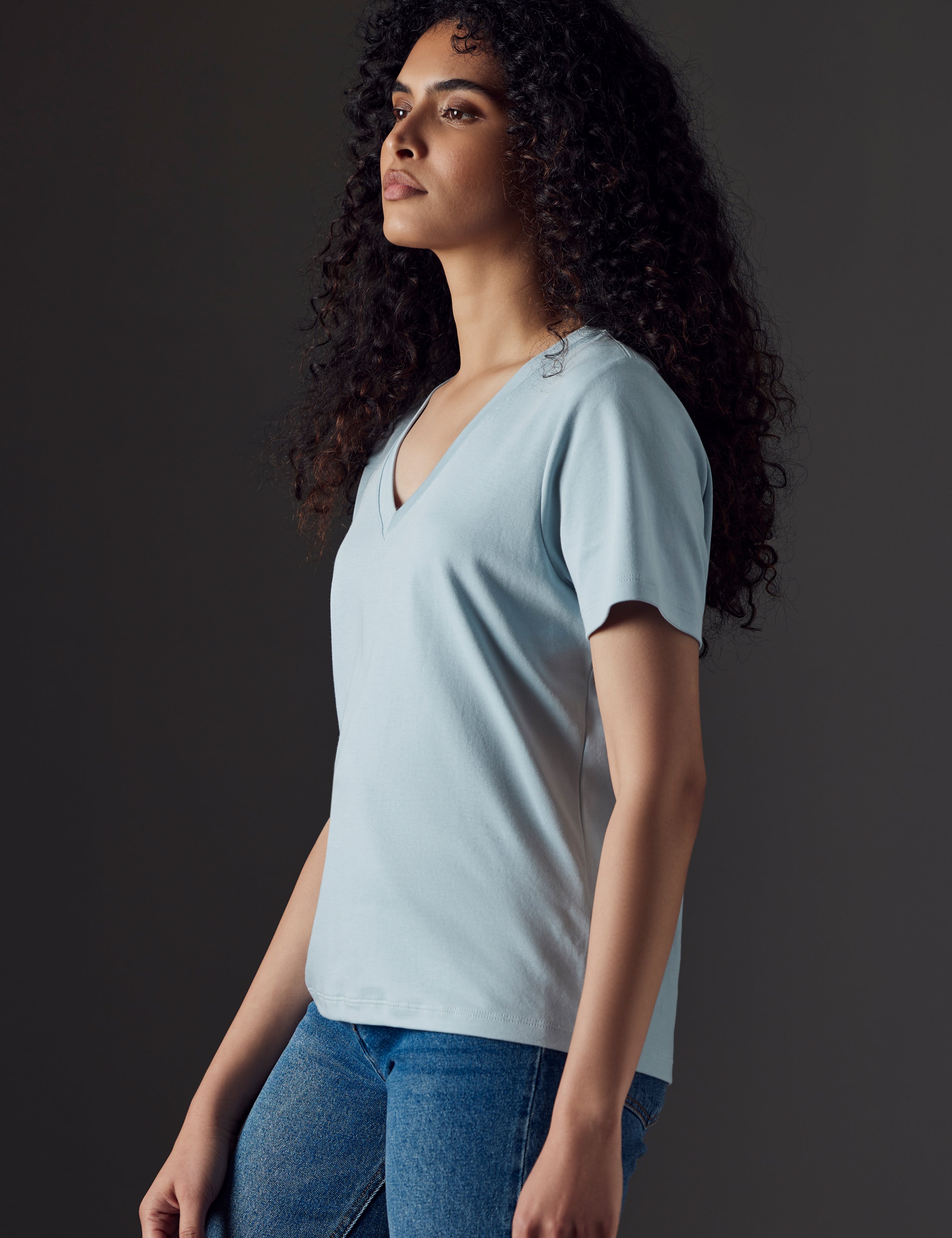 Woman wearing blue organic cotton v neck from AETHER Apparel