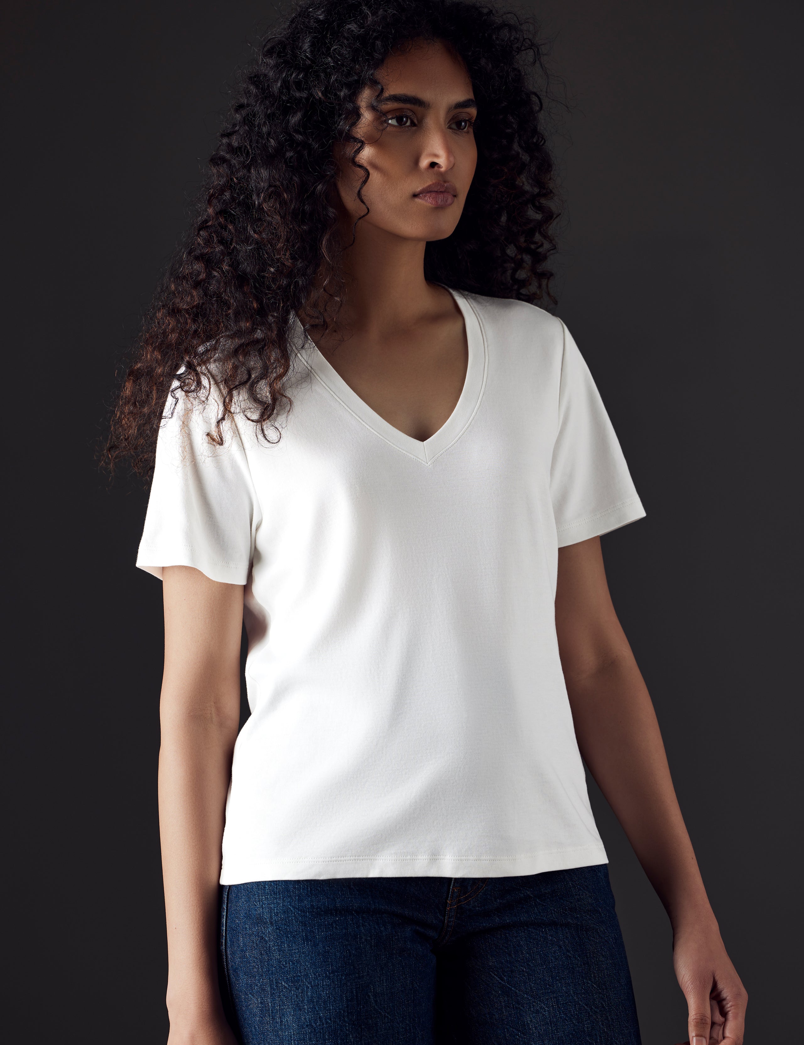 Woman wearing white organic cotton v neck from AETHER Apparel