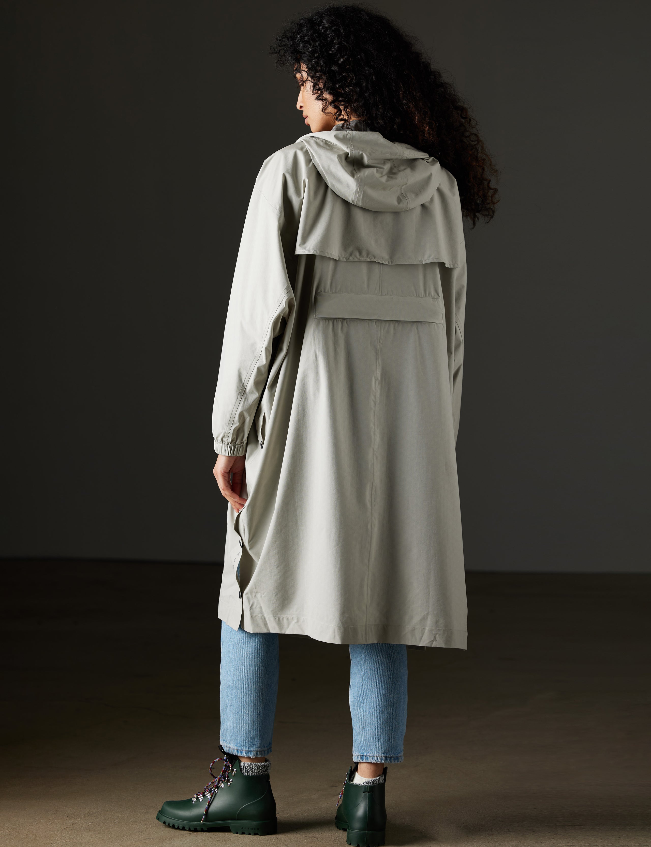 Back view of woman wearing grey poncho from AETHER Apparel