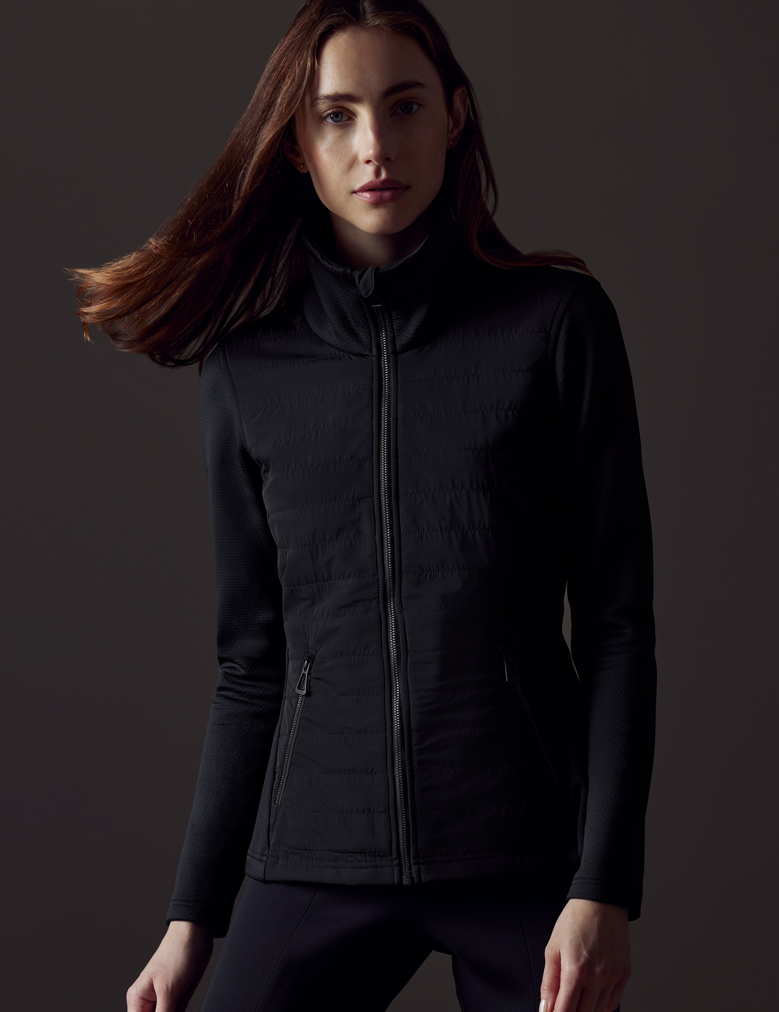 Woman wearing black full-zip from AETHER Apparel