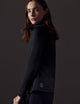 Woman wearing black full-zip from AETHER Apparel