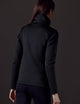 Back view of woman wearing black full-zip from AETHER Apparel