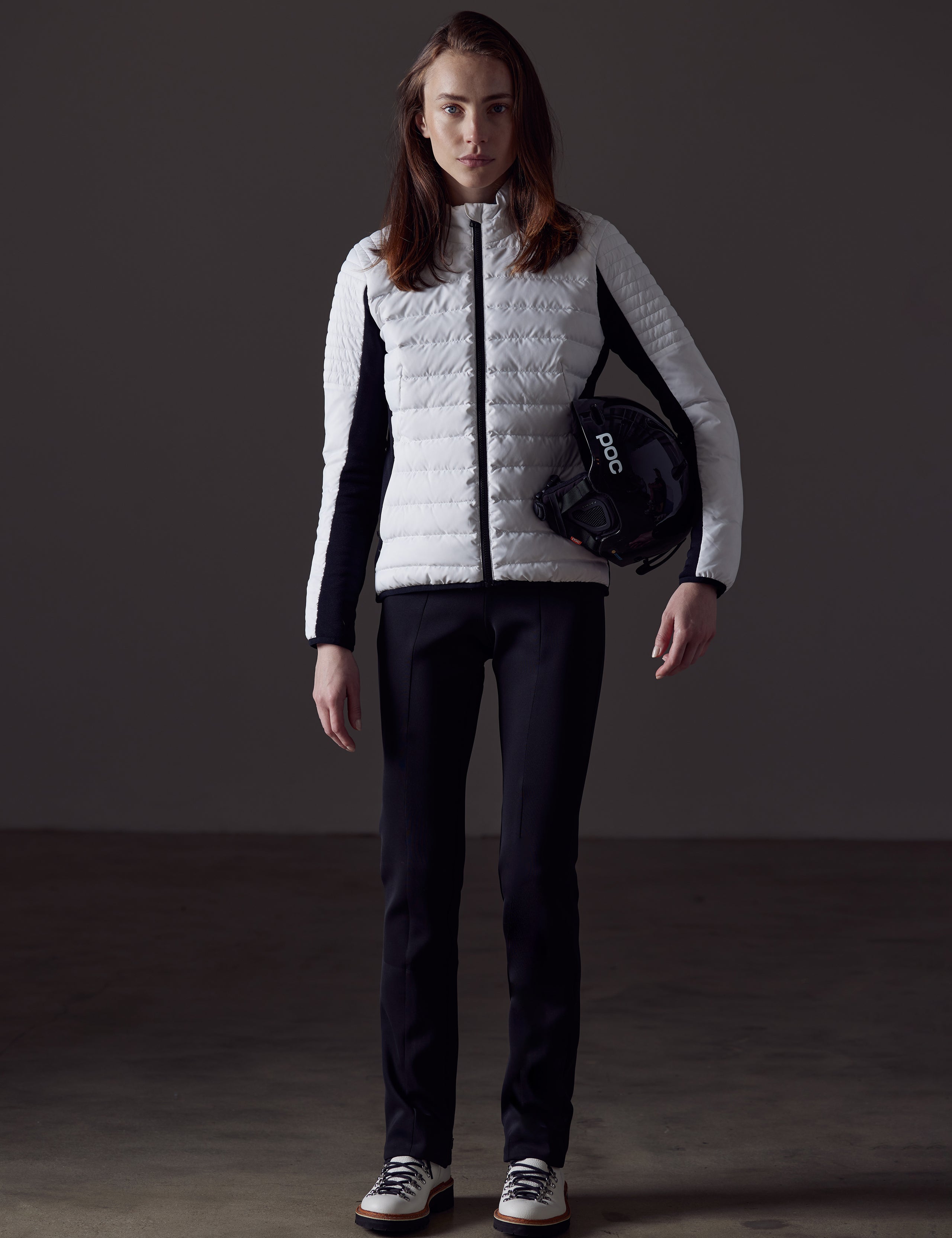 Woman wearing white quilted snow jacket from AETHER Apparel