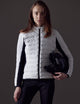 Woman wearing white quilted snow jacket from AETHER Apparel