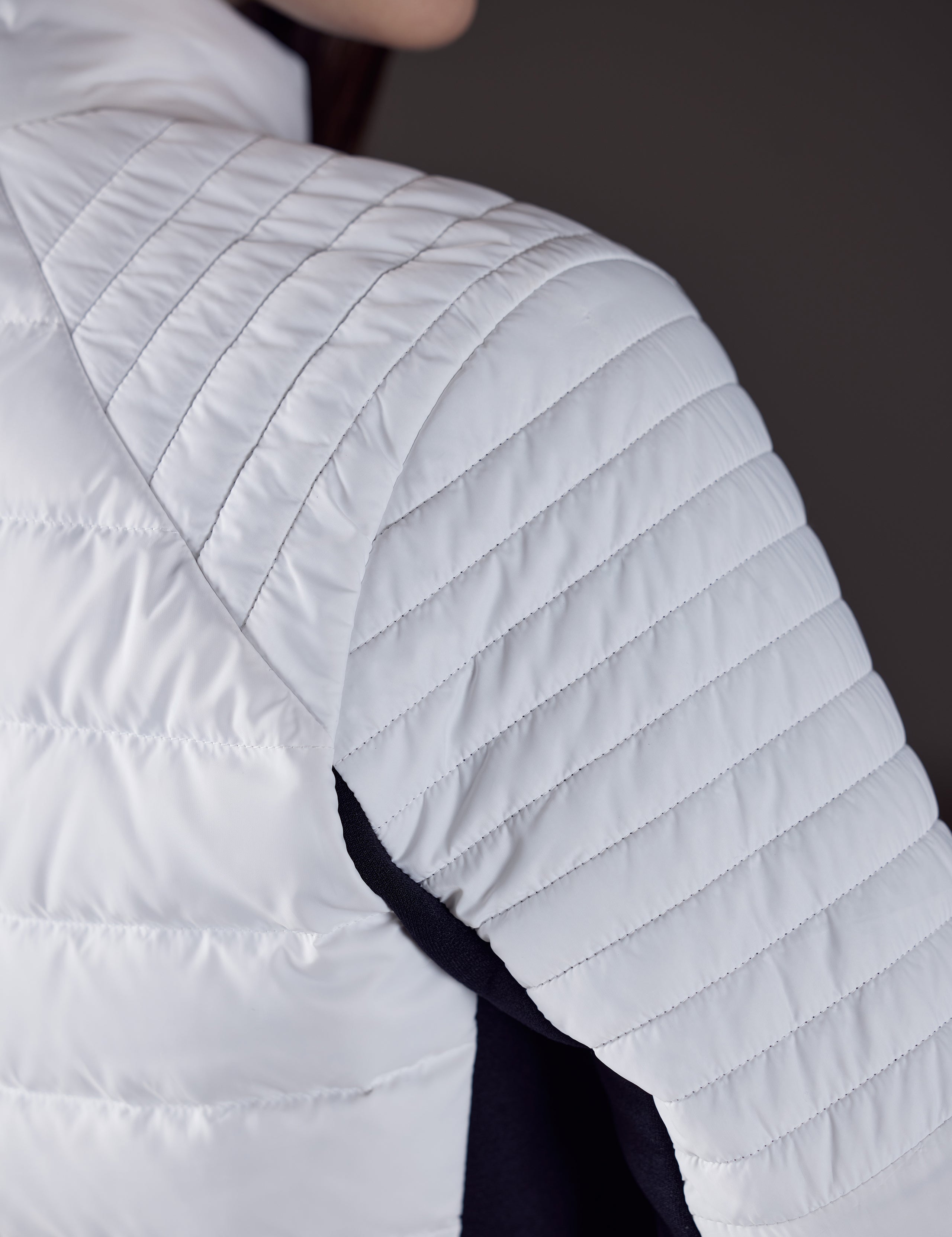 Close view of women's white quilted snow jacket from AETHER Apparel