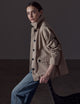 Woman wearing light brown button-up jacket from AETHER Apparel 