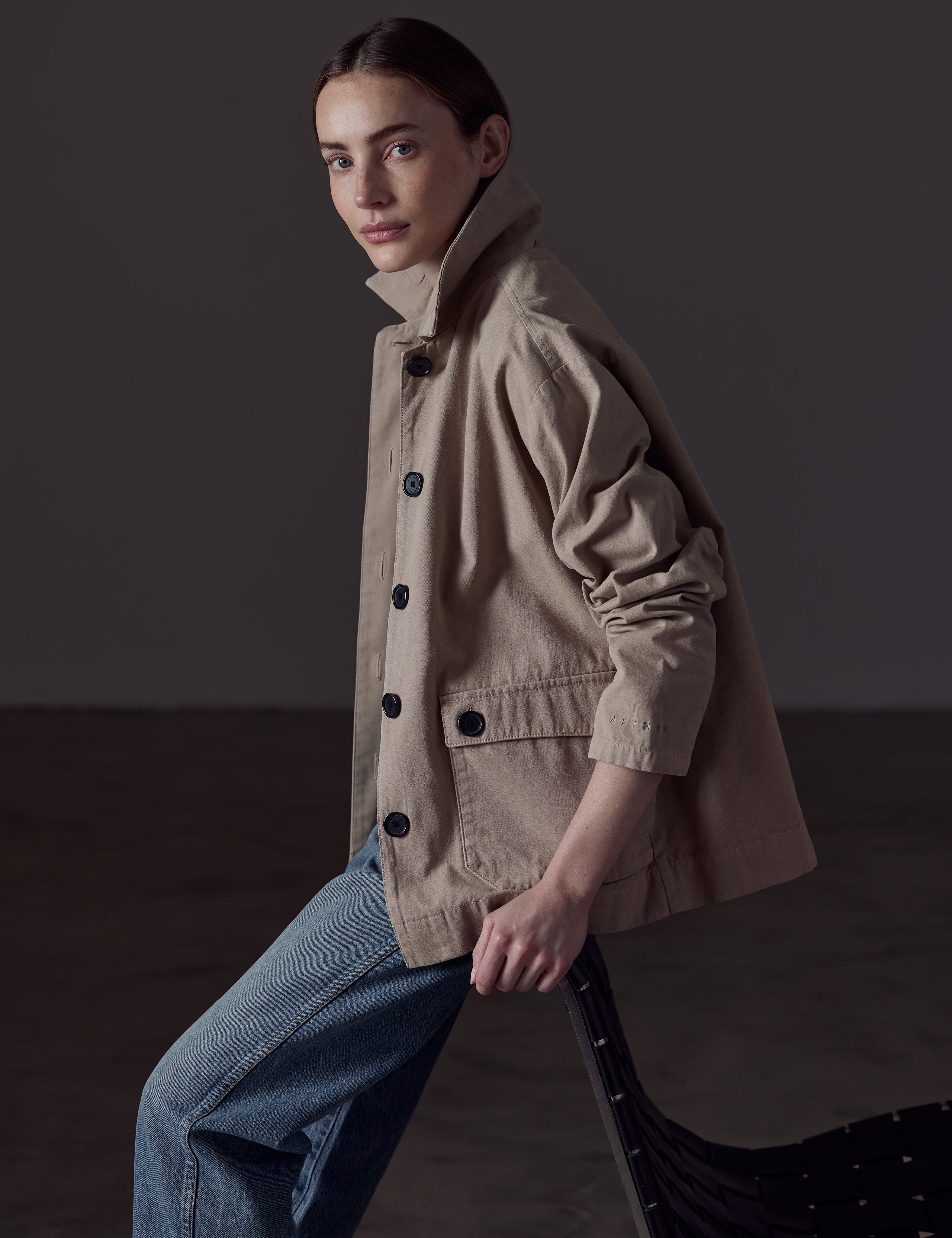 Woman wearing light brown button-up jacket from AETHER Apparel 