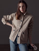 Woman wearing light brown button-up jacket from AETHER Apparel 