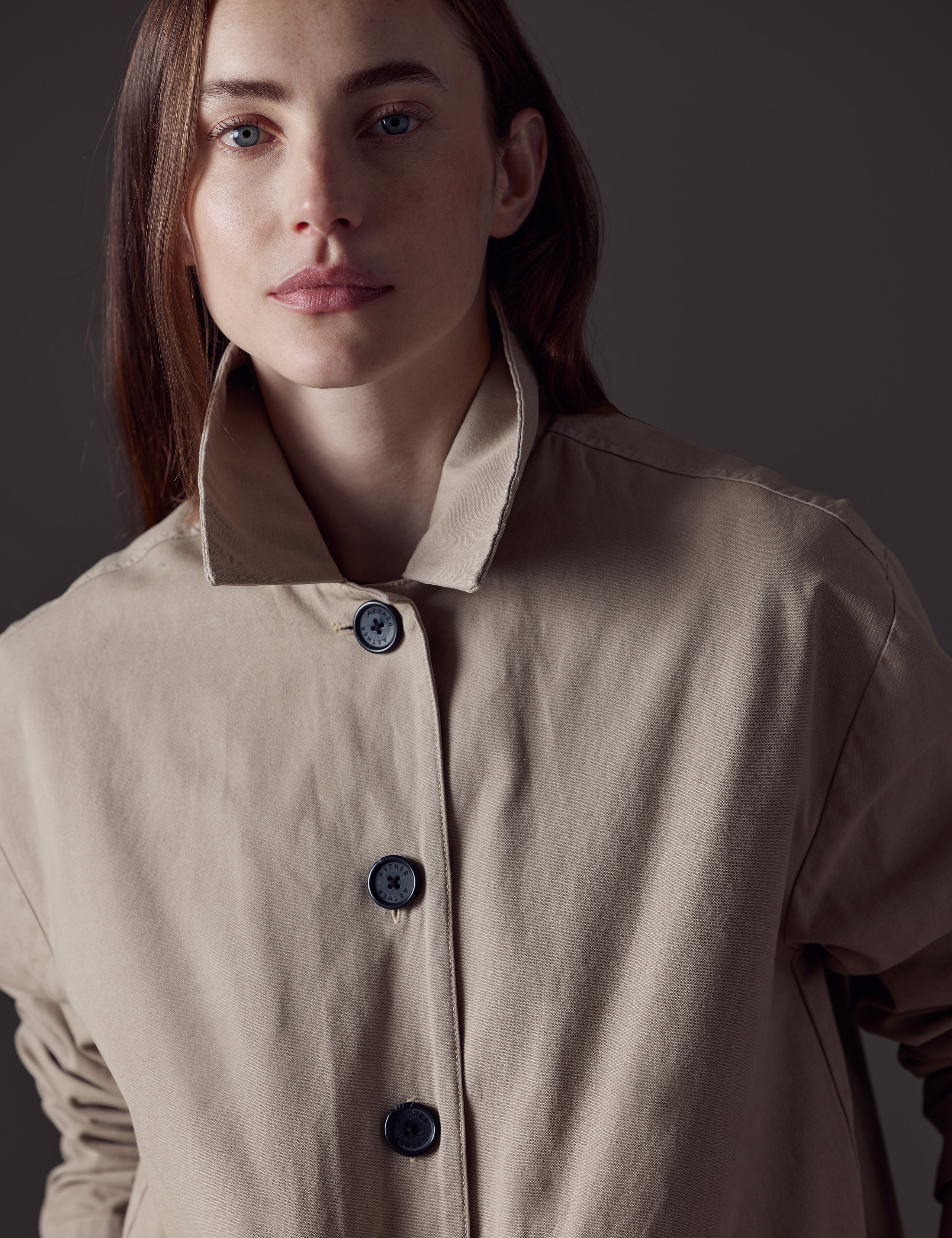 Woman wearing light brown button-up jacket from AETHER Apparel 